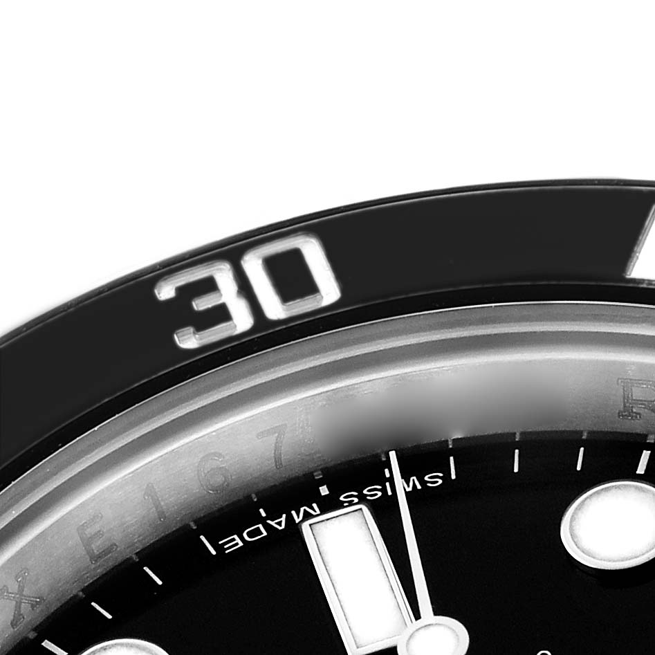 The image shows a close-up of the bezel and dial of a Rolex Submariner 114060 Men's Stainless Steel Black Dial, highlighting the "30" marking and part of the "Swiss Made" text.