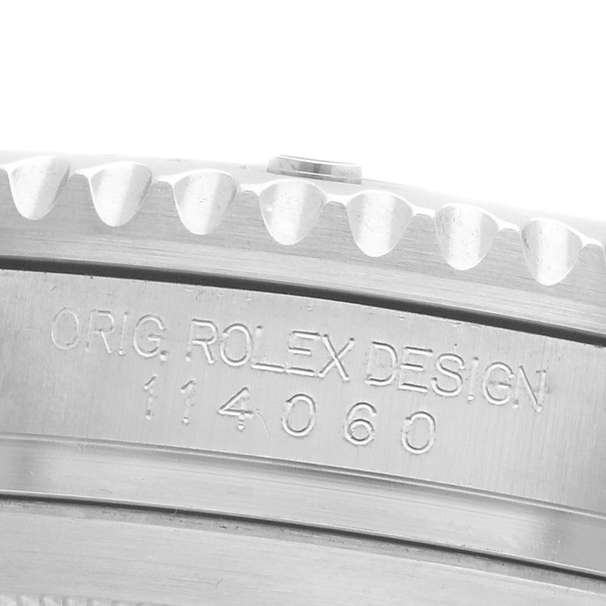The image shows a close-up of the case side, engraved with "ORIG. ROLEX DESIGN 114060," of a Rolex Submariner 114060 Men's Stainless Steel Black Dial.
