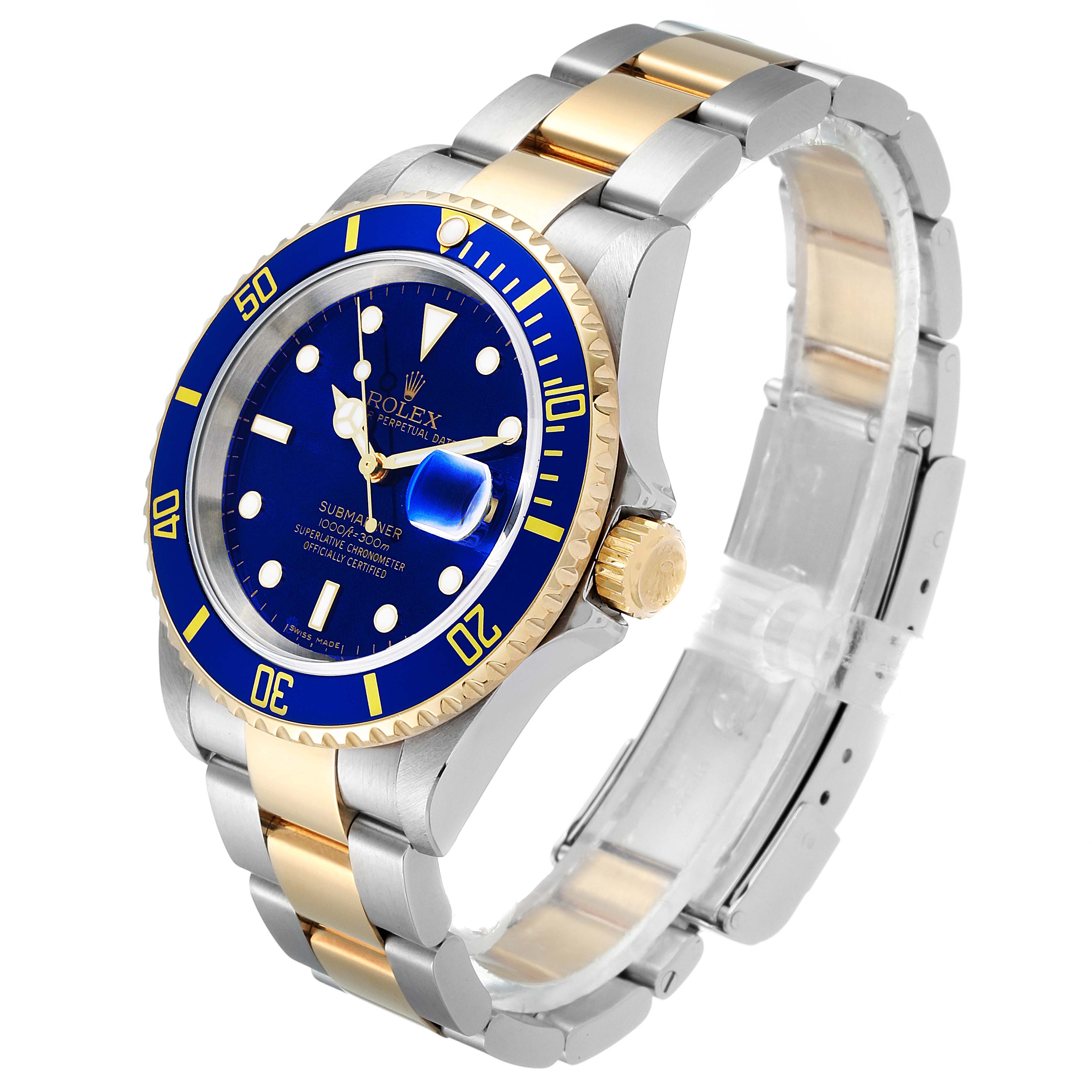 The Rolex Submariner 16613 Men's Steel and Gold (two tone) Blue Dial 16613 Men's Steel and Gold (two tone) Blue Dial watch is displayed at a three-quarter angle showing the blue dial, gold bezel, and two-tone bracelet.