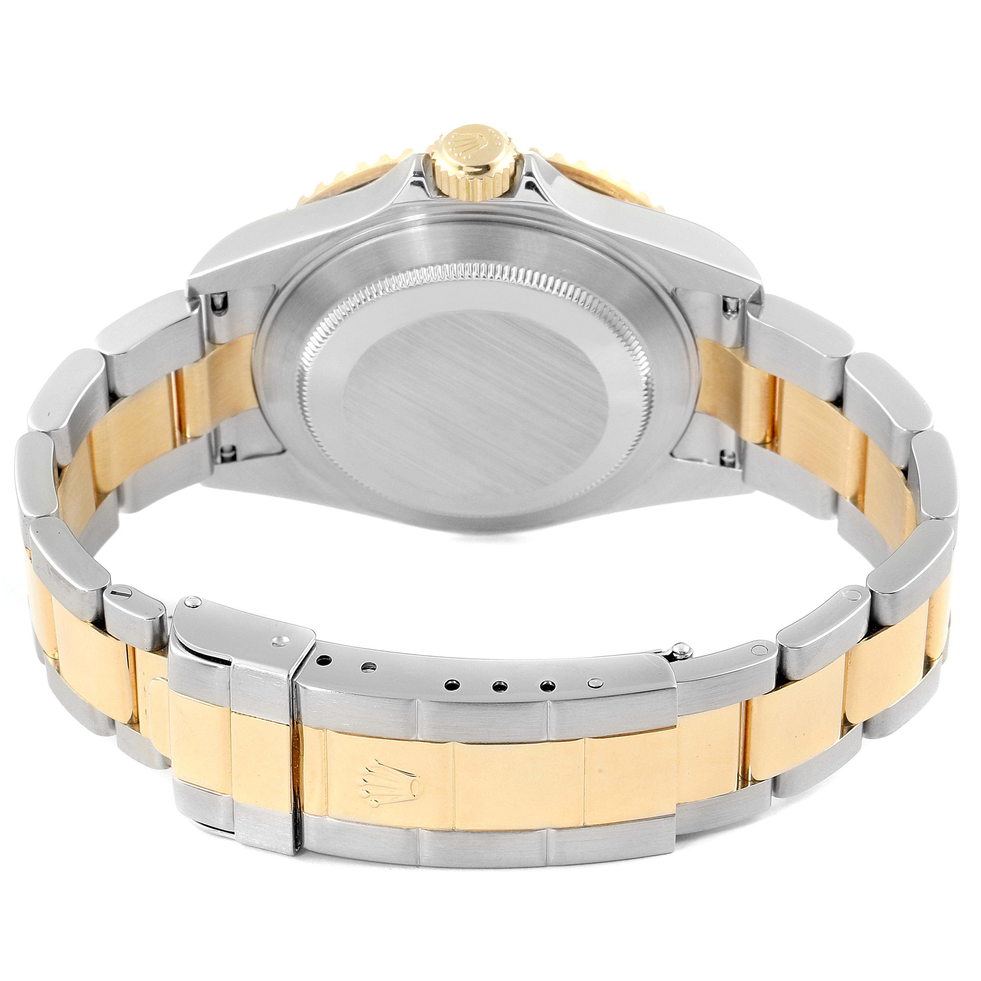 The Rolex Submariner 16613 Men's Steel and Gold (two tone) Blue Dial 16613 Men's Steel and Gold (two tone) Blue Dial watch is shown from the back, highlighting its stainless steel and gold bracelet, case back, and crown.