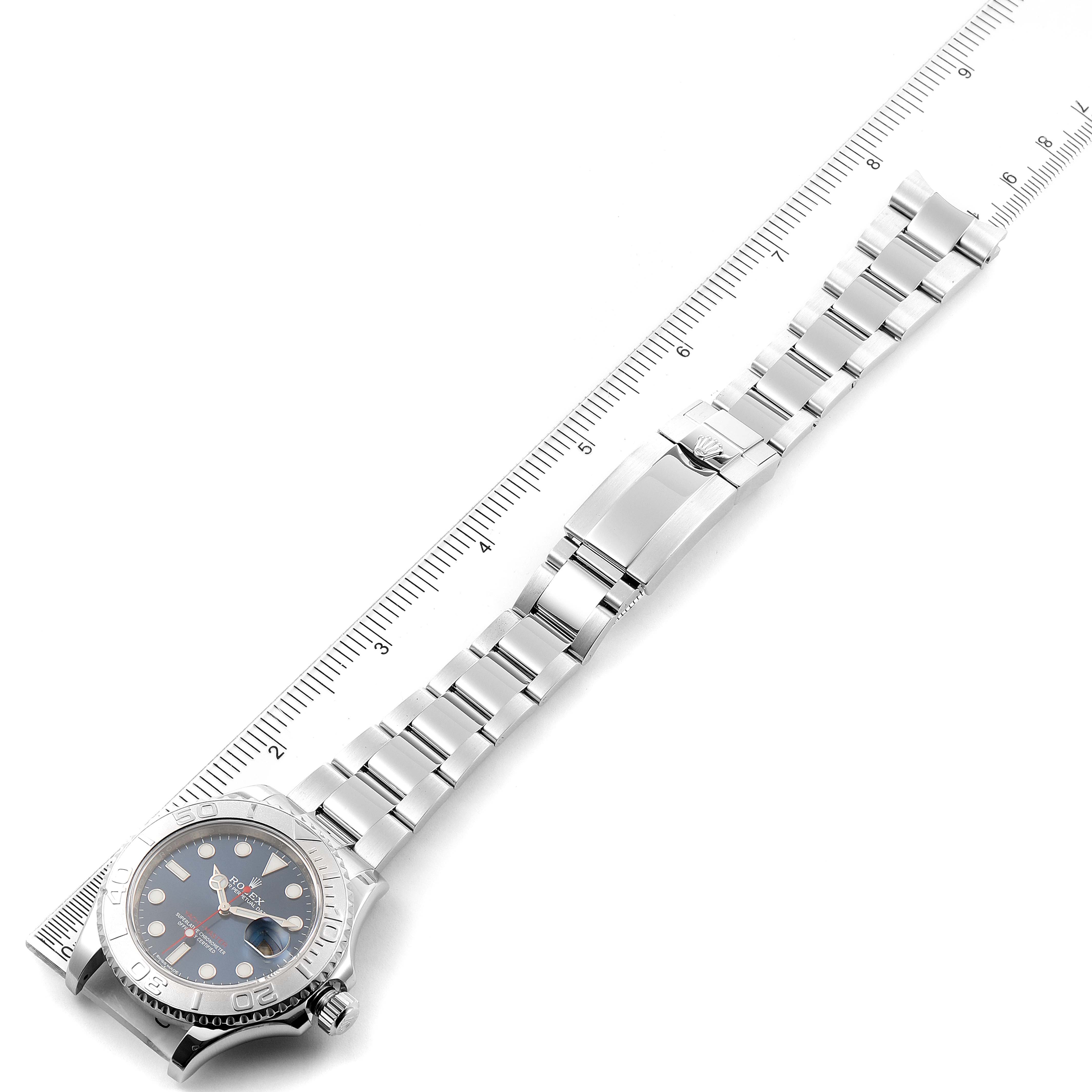 The Rolex Yacht-Master 116622 Men's Stainless Steel Blue Dial 116622 Men's Stainless Steel Blue Dial watch is photographed from above, showing the dial, bezel, bracelet, and clasp alongside a ruler for scale.