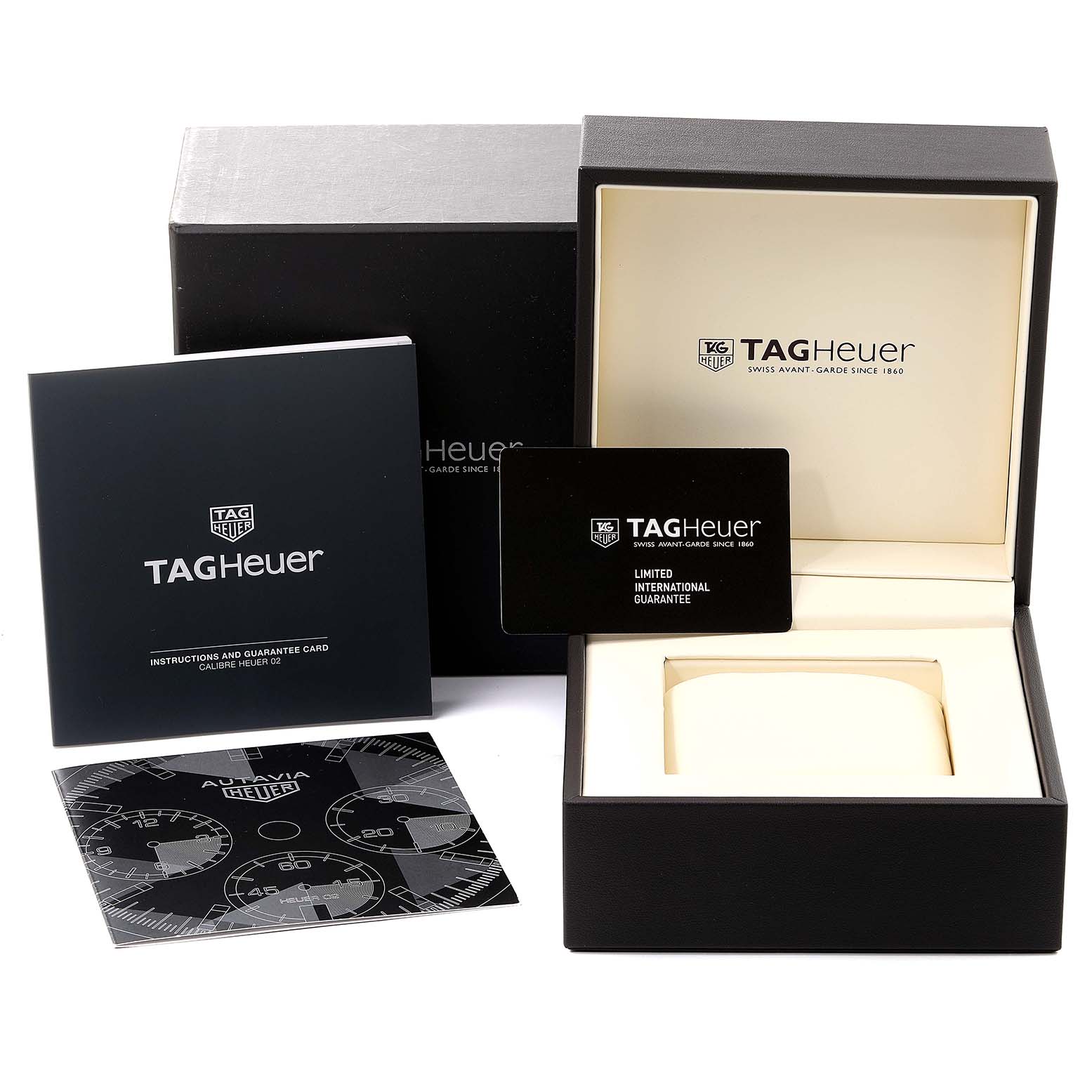 The image shows the open box, guarantee card, manual, and packaging for an Autavia model by Tag Heuer.