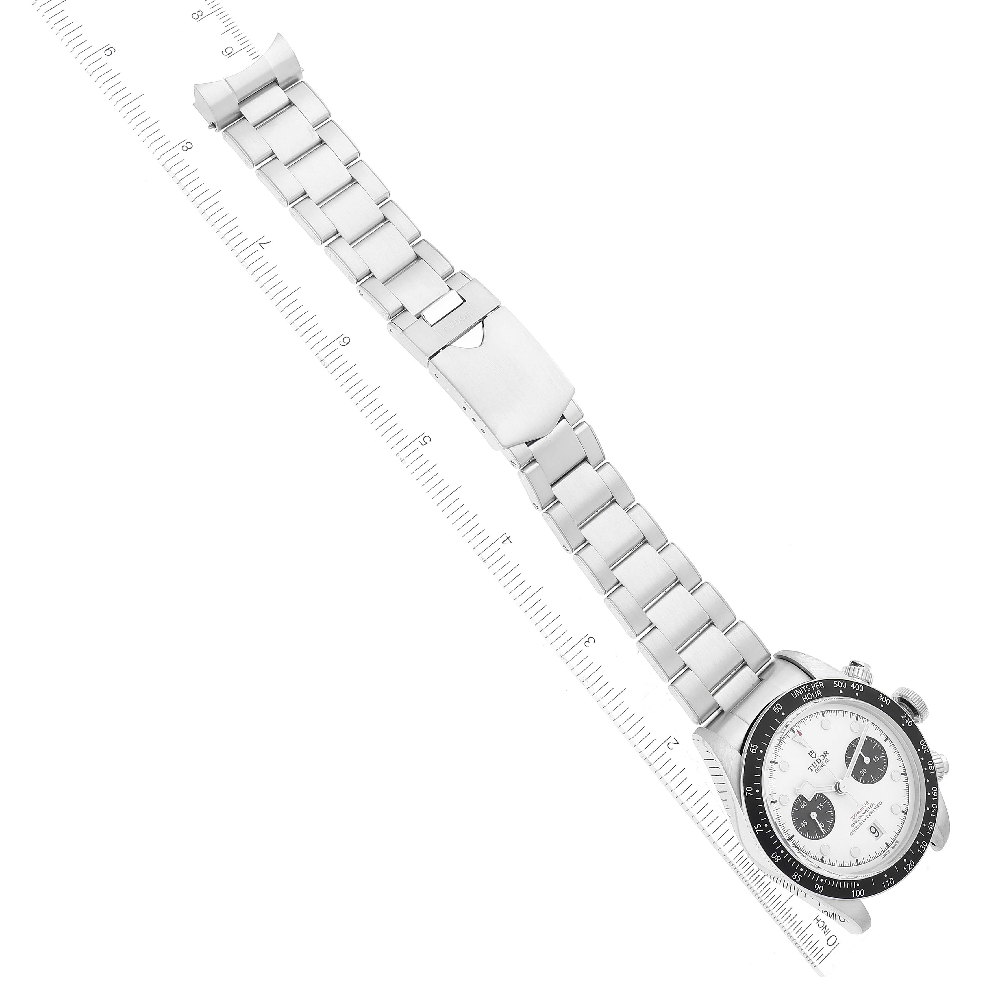 The image shows a Tudor Heritage Black Bay M79360N-0002 Men's Stainless Steel White Dial M79360N-0002 Men's Stainless Steel White Dial watch laid flat, with the bracelet extended and a measuring scale beside it.
