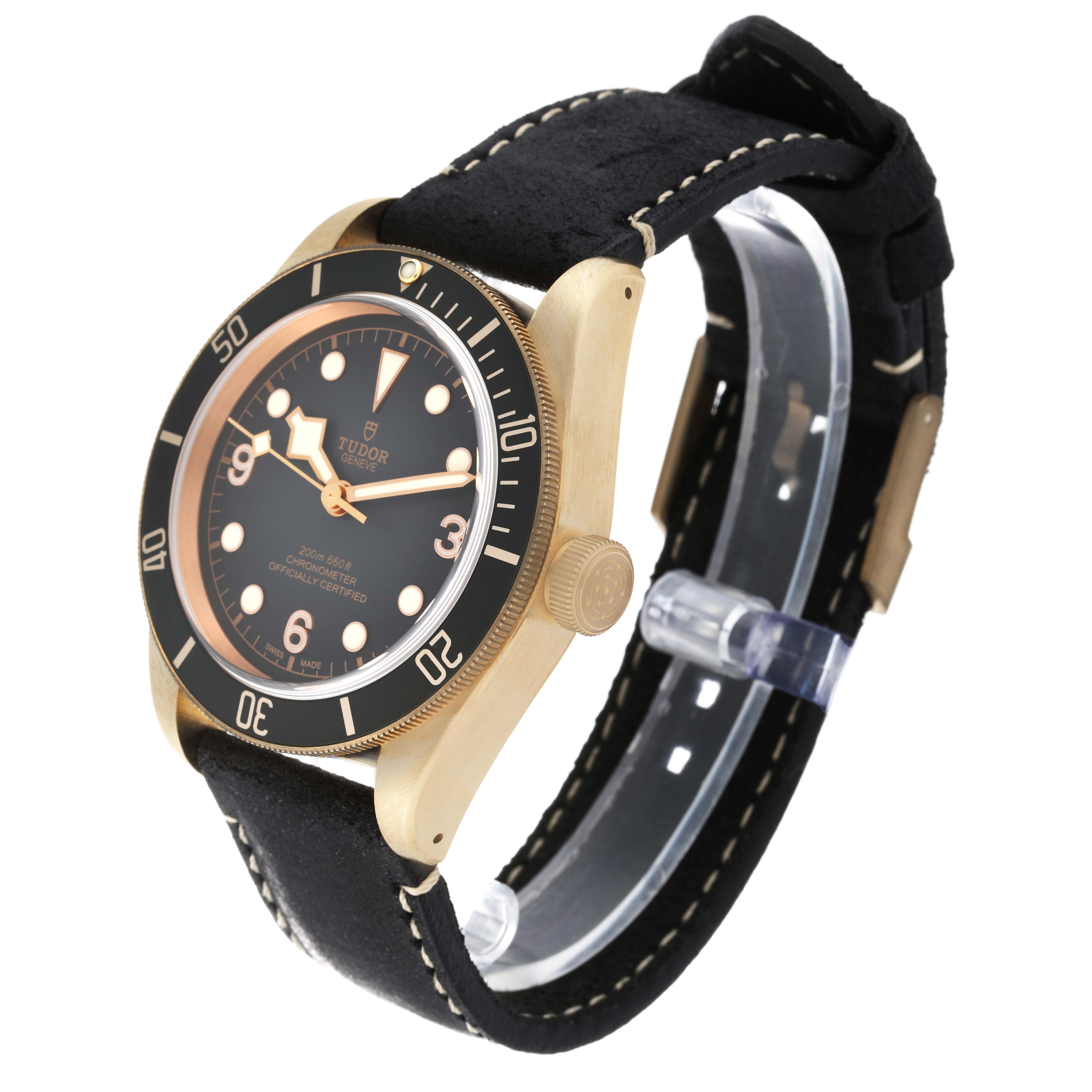 The image shows a Tudor Heritage Black Bay 79250BA Men's Bronze Black Dial 79250BA Men's Bronze Black Dial watch at a three-quarter angle with a black dial, gold-tone case, and black strap.