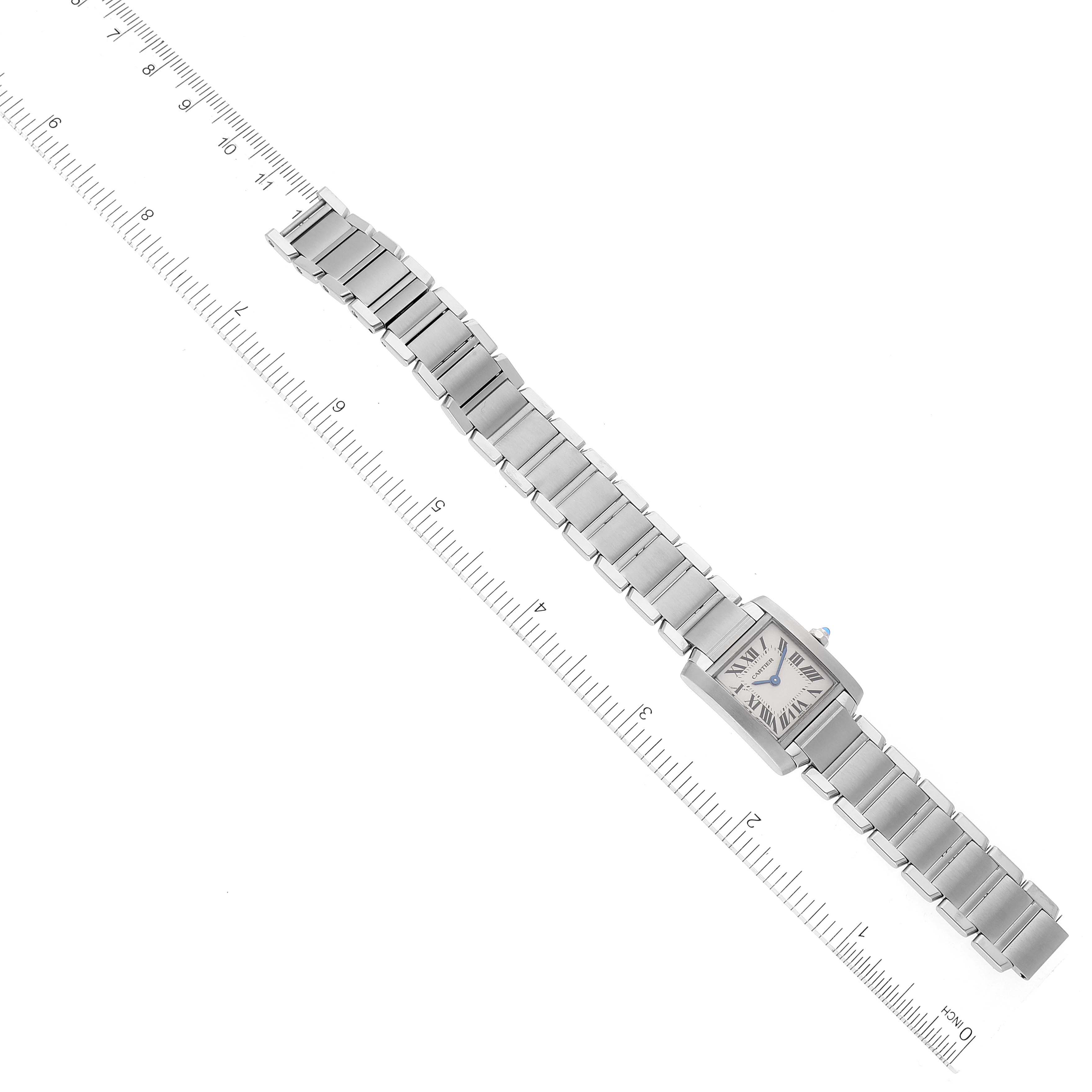 The image shows a Cartier Tank Française watch laid flat with the full bracelet and face visible alongside a ruler for scale.