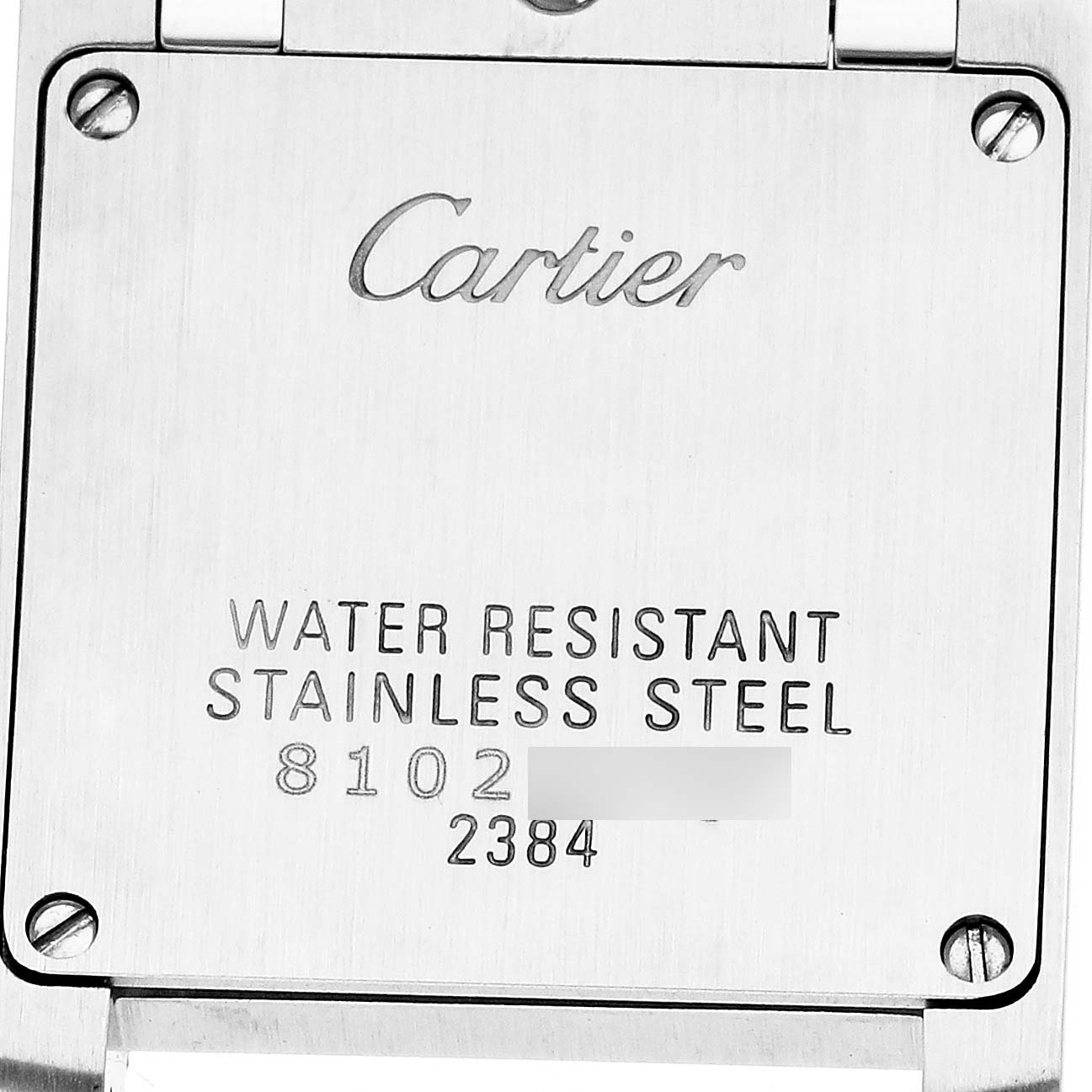 The image shows the back case of a Cartier Tank Française watch with engraved details about material and model.