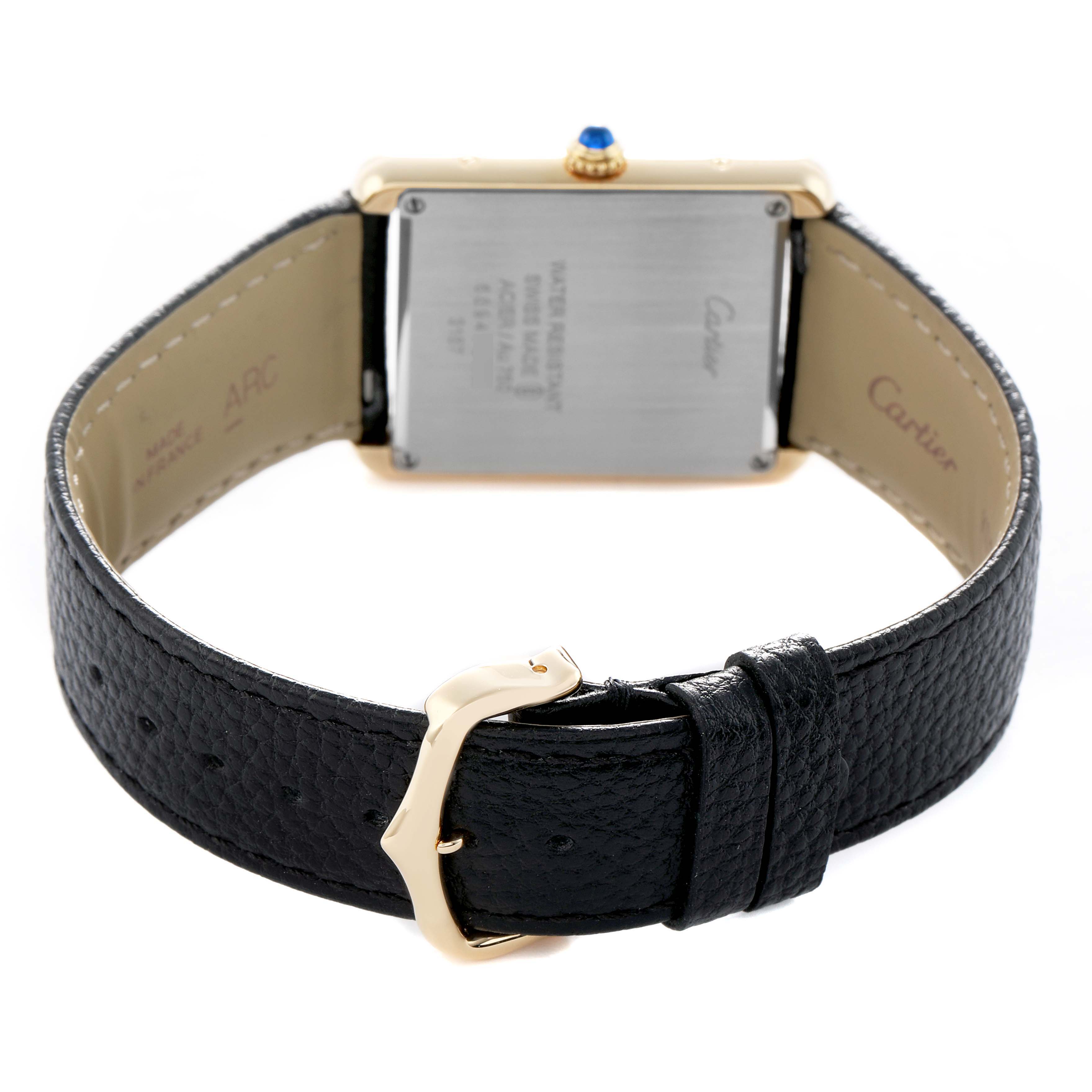 The image shows the back view of a Cartier Tank Solo W5200004 Men's Steel and Gold (two tone) Silver Dial with its case back, black leather strap, and gold buckle visible.