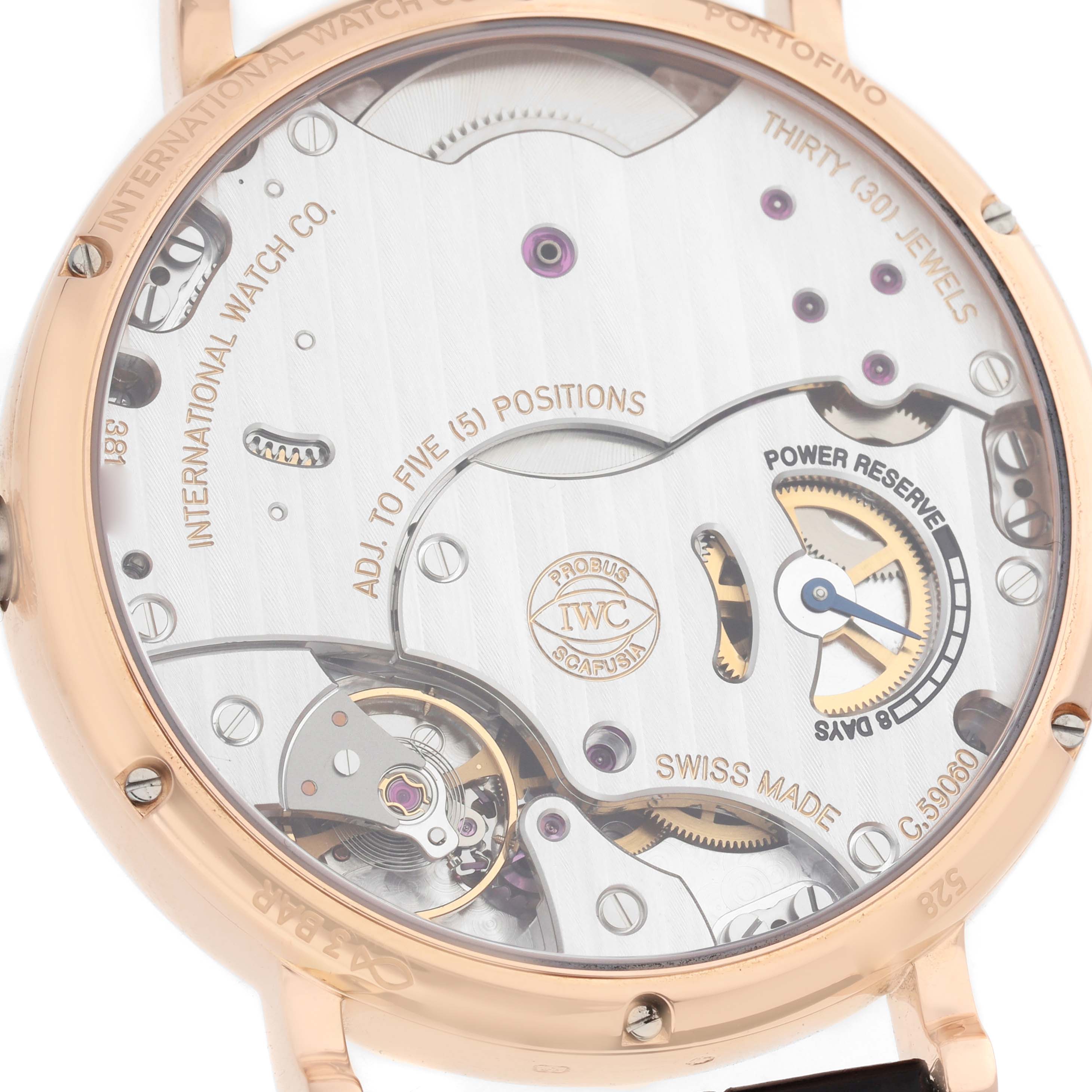 The image shows the case back of an IWC Portofino IW511101 Men's Rose Gold Silver Dial watch, highlighting its movement and power reserve mechanism.