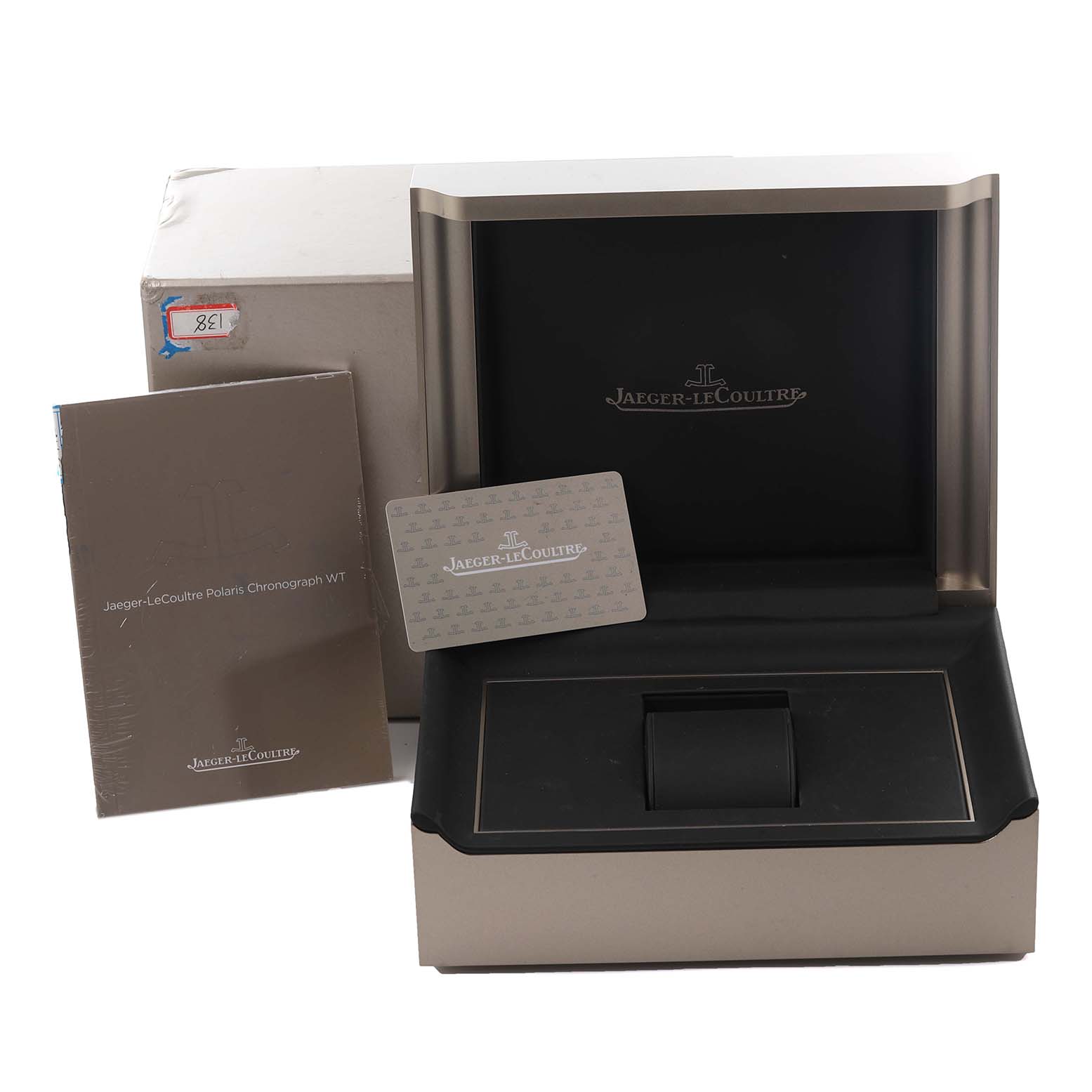 The image shows the packaging and accessories for a Jaeger-LeCoultre Master model, including the box, booklet, and card.