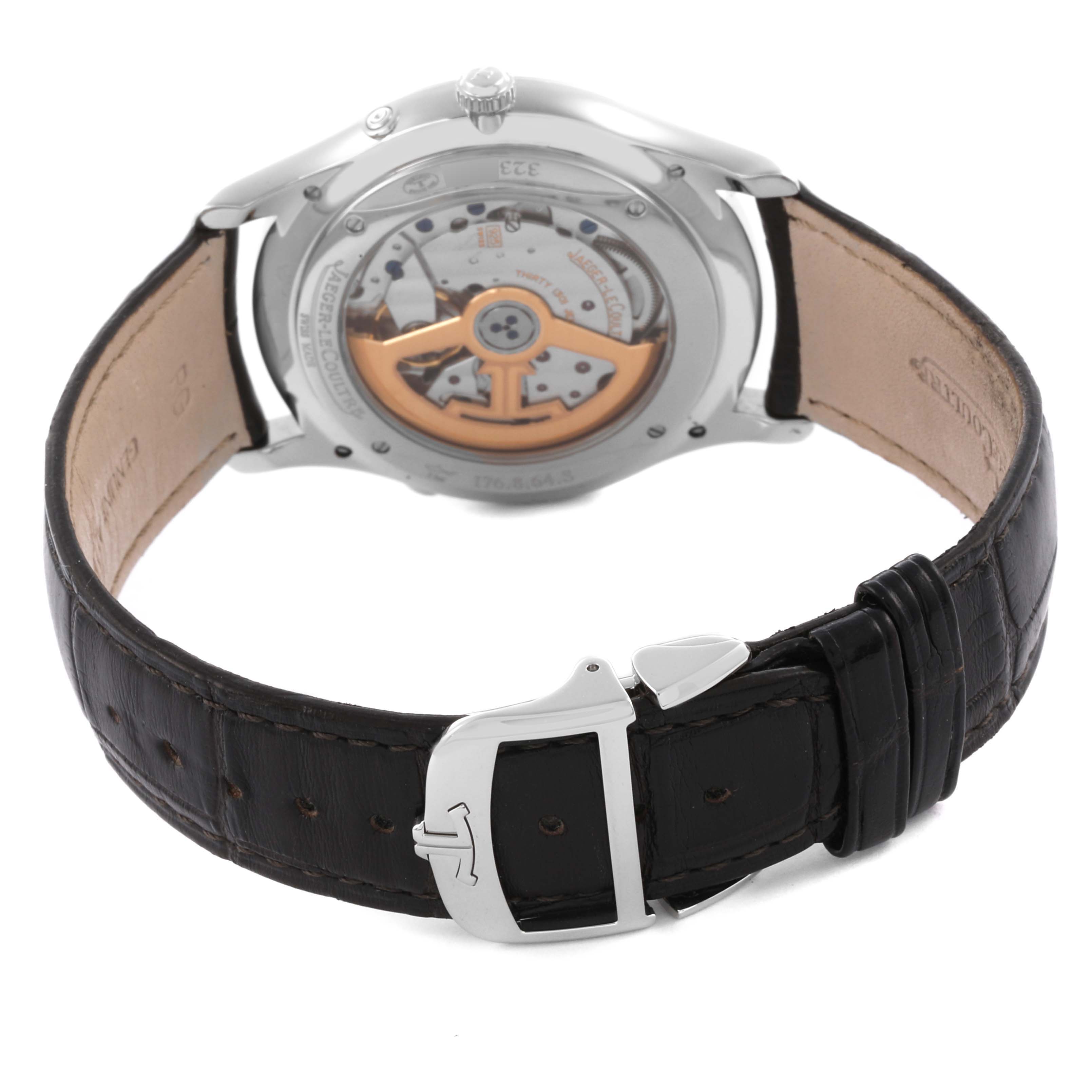 The image shows the back view of a Jaeger-LeCoultre Master watch, highlighting its movement and leather strap with buckle.