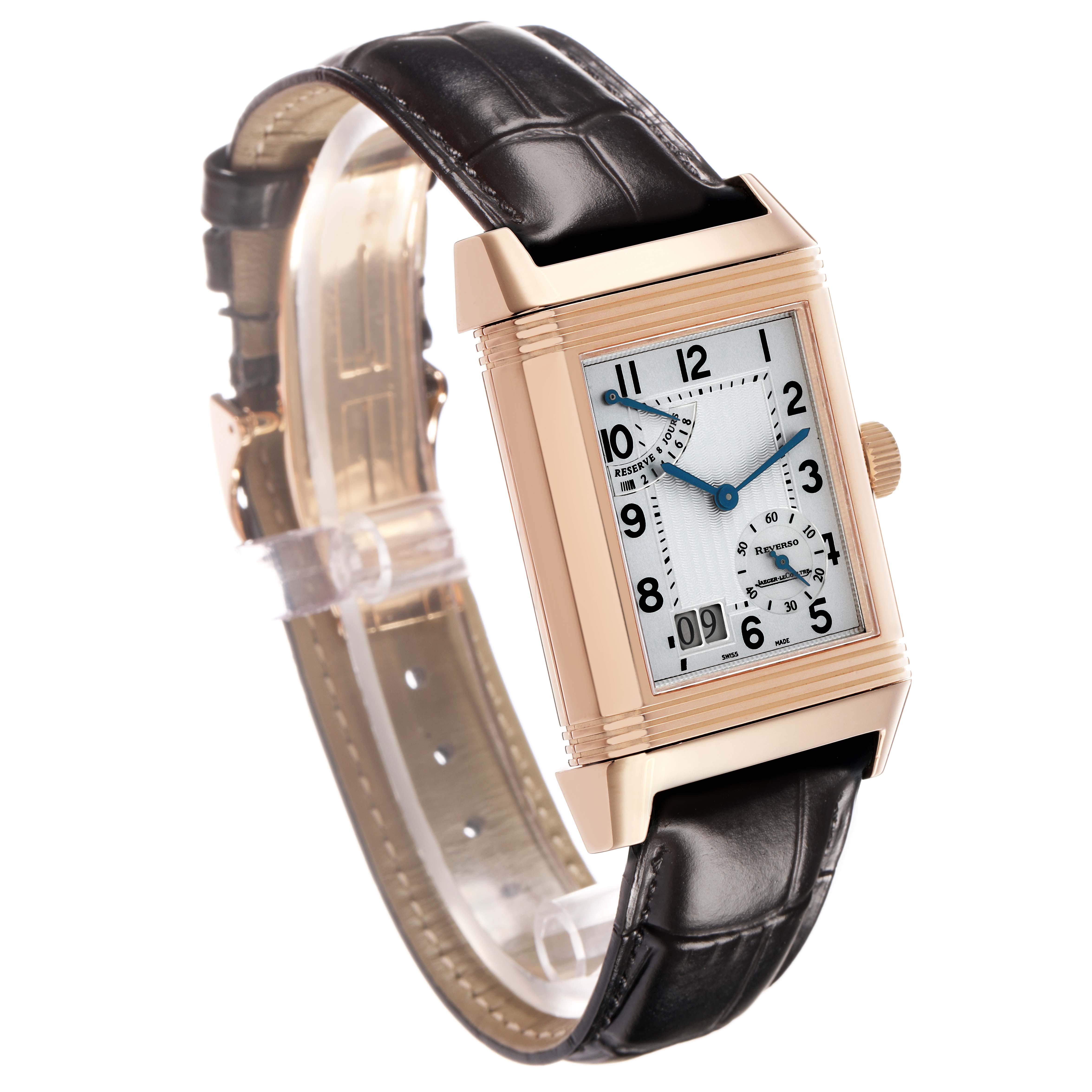 The Jaeger-LeCoultre Reverso watch is shown at an angled side view, highlighting the rectangular case, dial, and leather strap.
