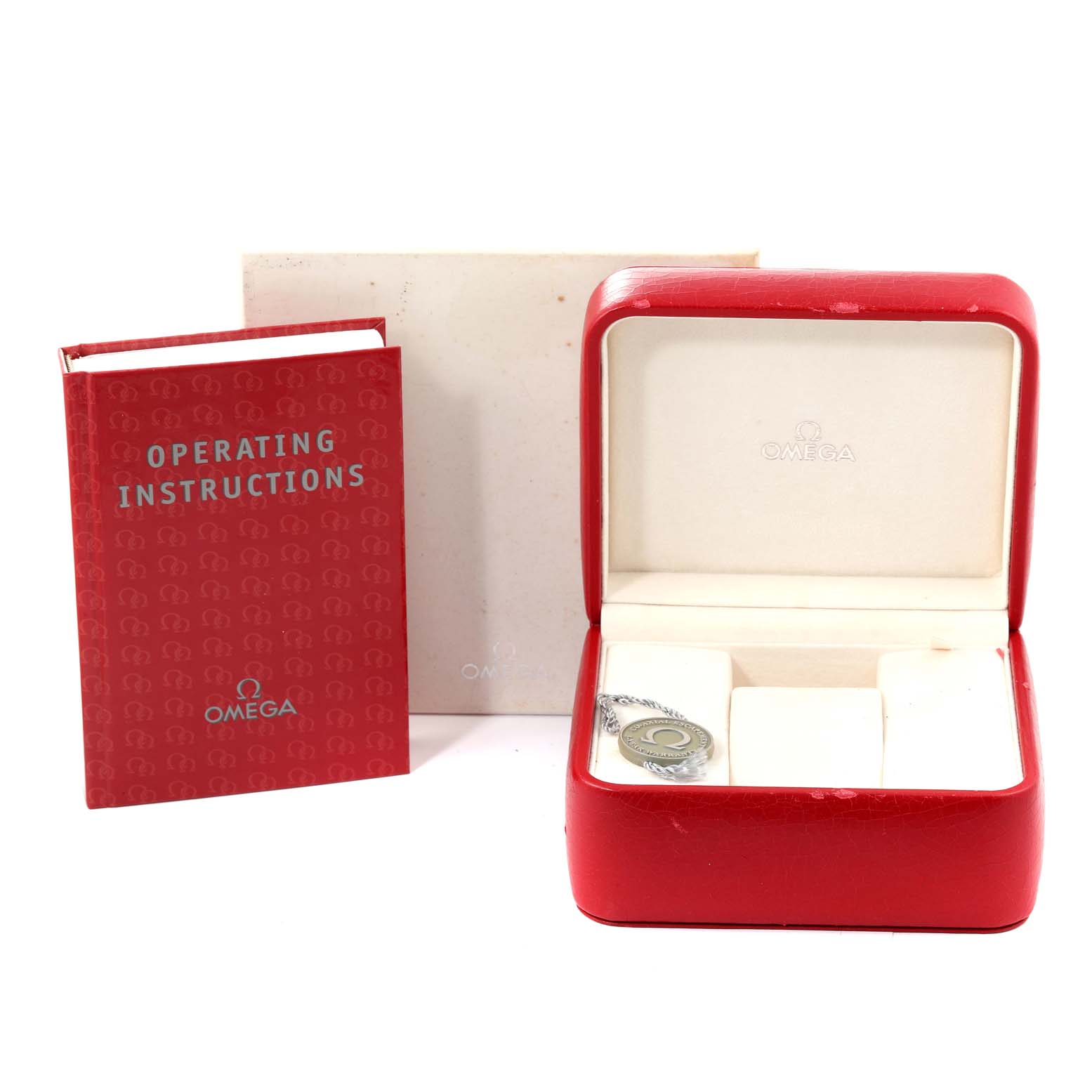 The image shows the Omega Planet Ocean 2210.50.00 Men's Stainless Steel Black Dial 2210.50.00 Men's Stainless Steel Black Dial watch's red operating instructions booklet, a red watch box, and a hang tag.