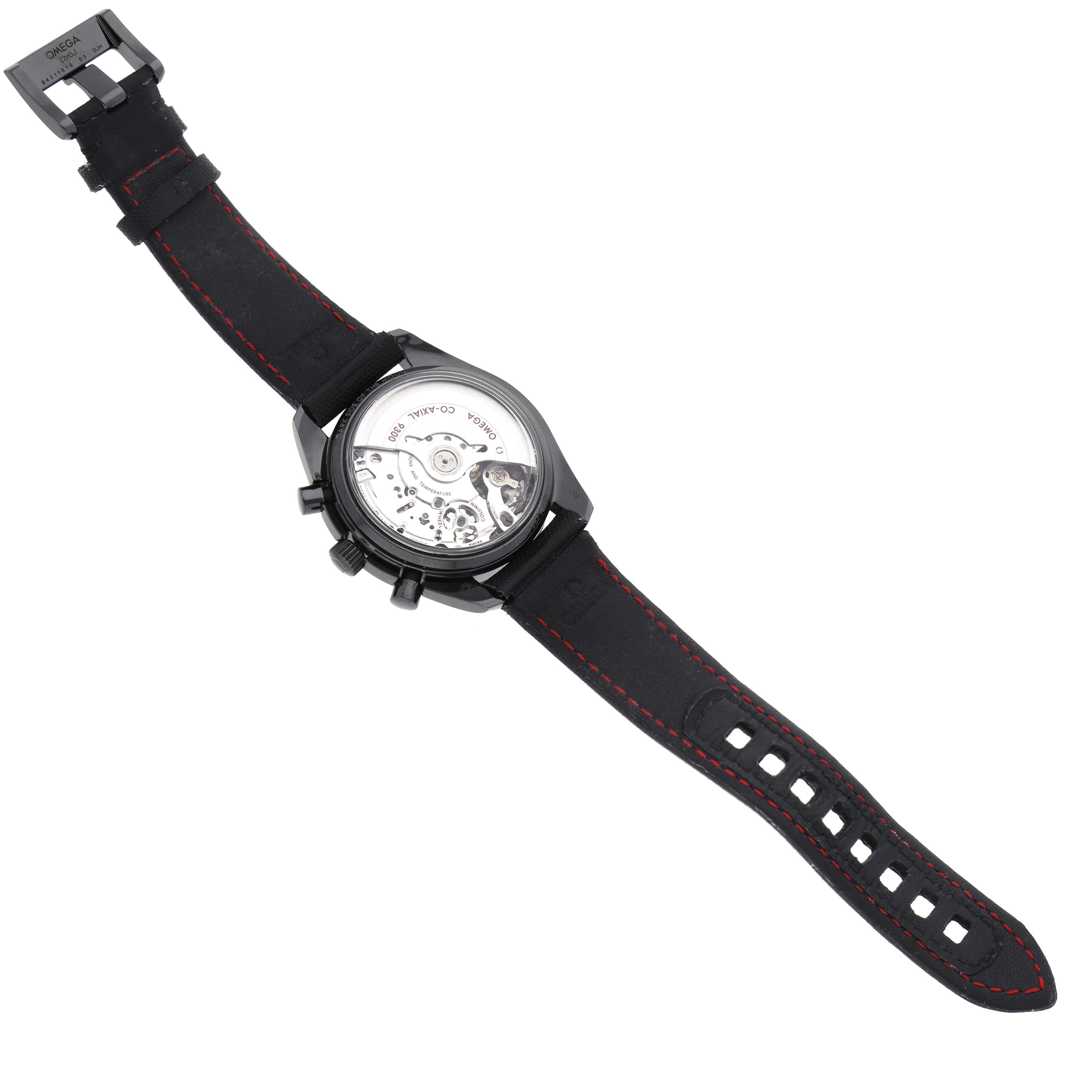 The Omega Speedmaster 311.92.44.51.01.003 Men's Ceramic Black Dial is shown from the back, highlighting its open case back and movement with a black strap and red stitching.