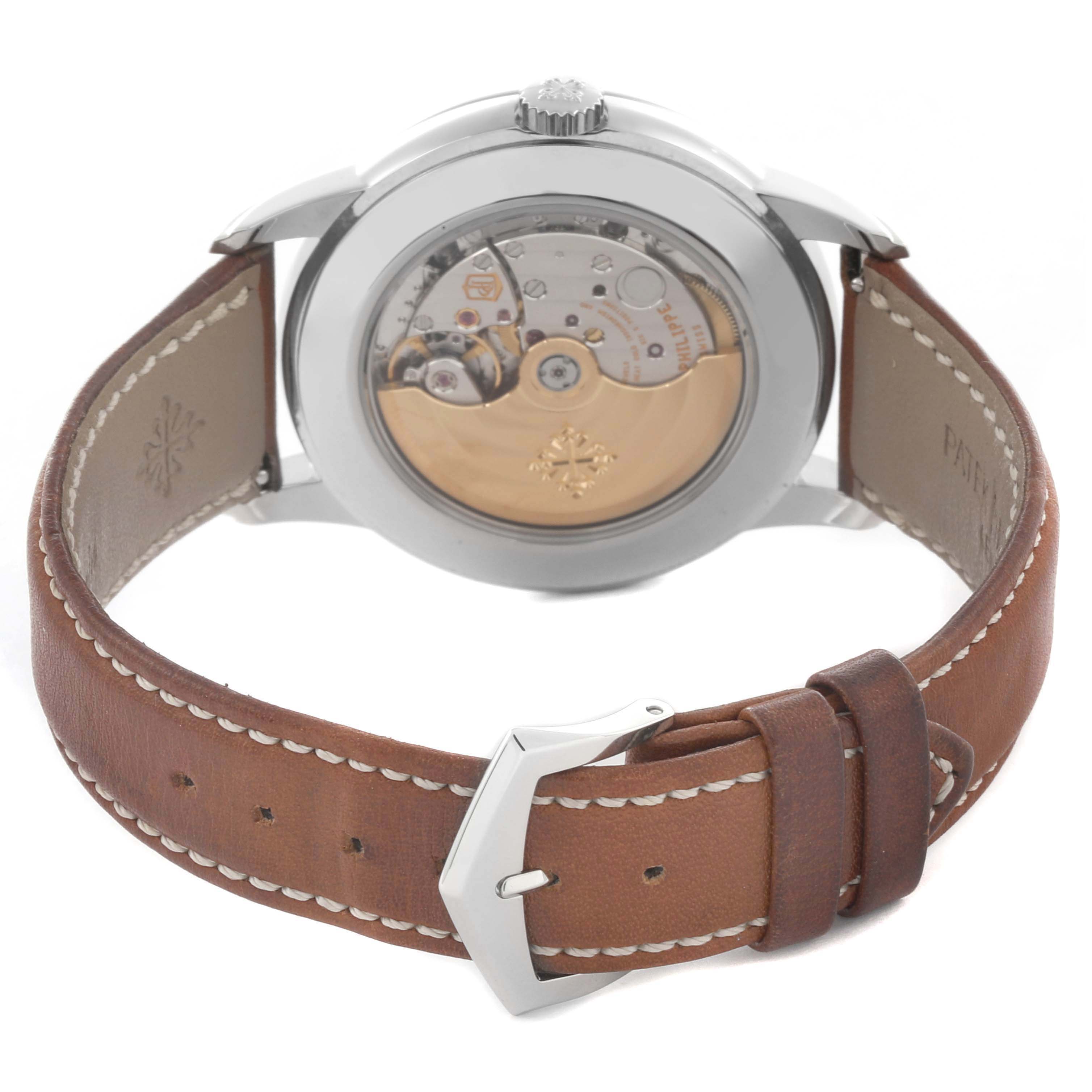 The Patek Philippe Complications 5212A-001 Men's Stainless Steel Silver Dial 5212A-001 Men's Stainless Steel Silver Dial watch is shown from the back, displaying its movement and brown leather strap.