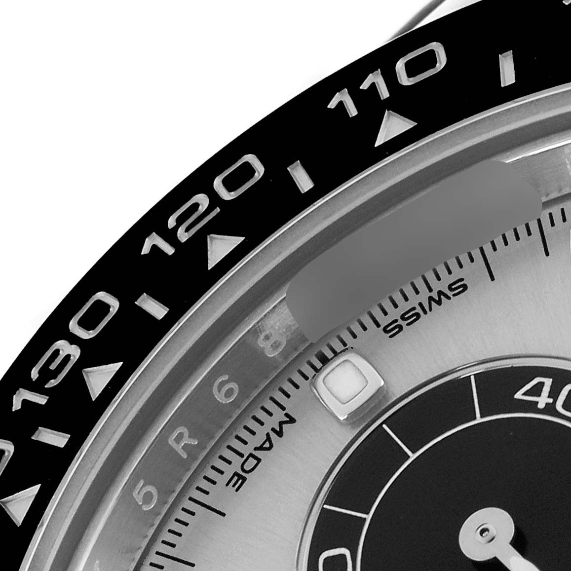 The image shows a close-up of the bezel and part of the dial of a Rolex Daytona 116519LN Men
s White Gold Silver Dial 116519LN Men
s White Gold Silver Dial watch, highlighting numbers and markers.