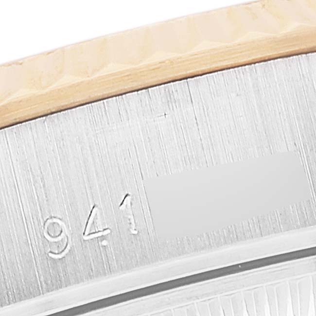 The image shows a close-up view of the Rolex Datejust 69173 Women's Steel and Gold (two tone) White Dial 69173 Women's Steel and Gold (two tone) White Dial model's case, focusing on the serial number engraving.