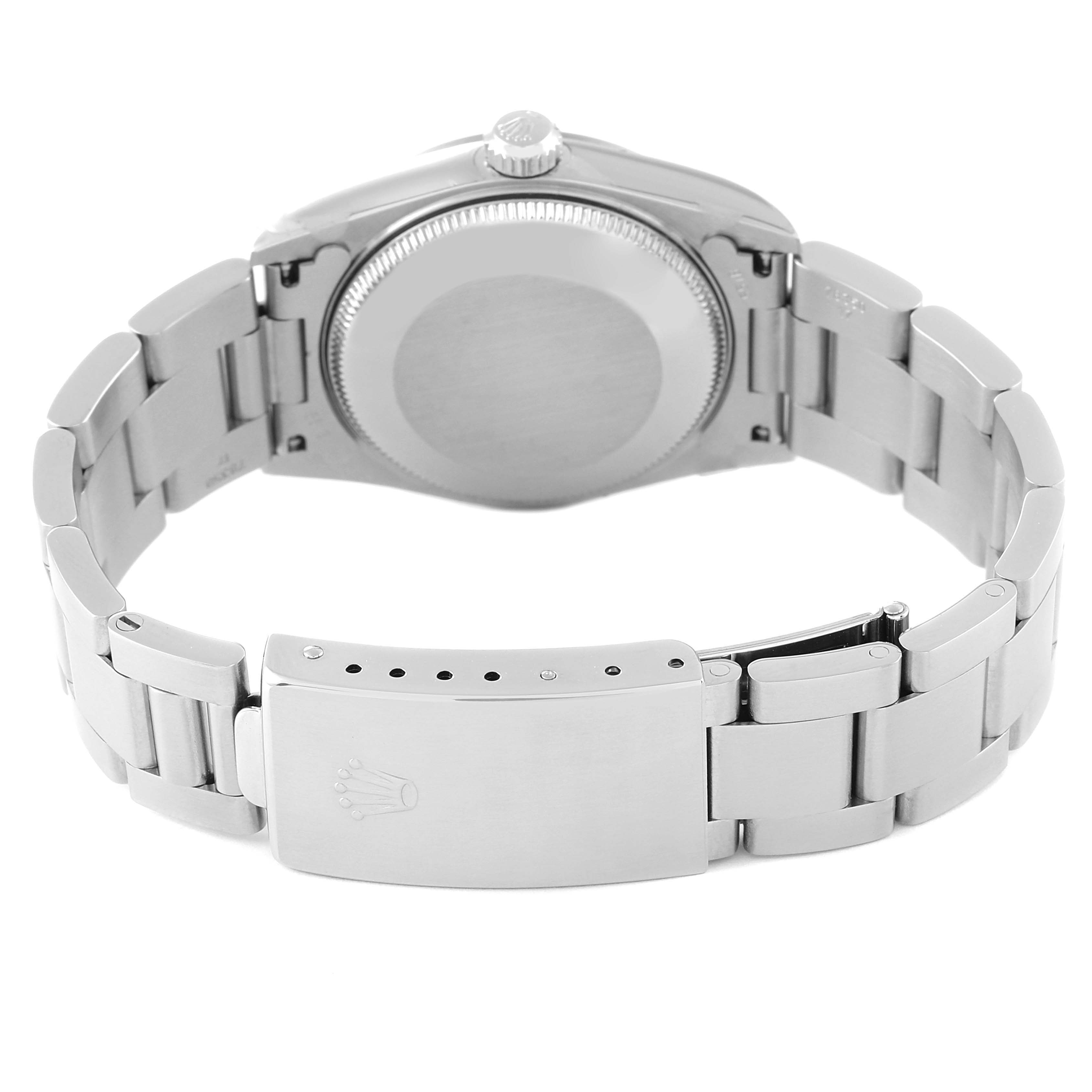 This image shows the rear side of the case and bracelet clasp of a Mid-Size Rolex watch from a back angle.