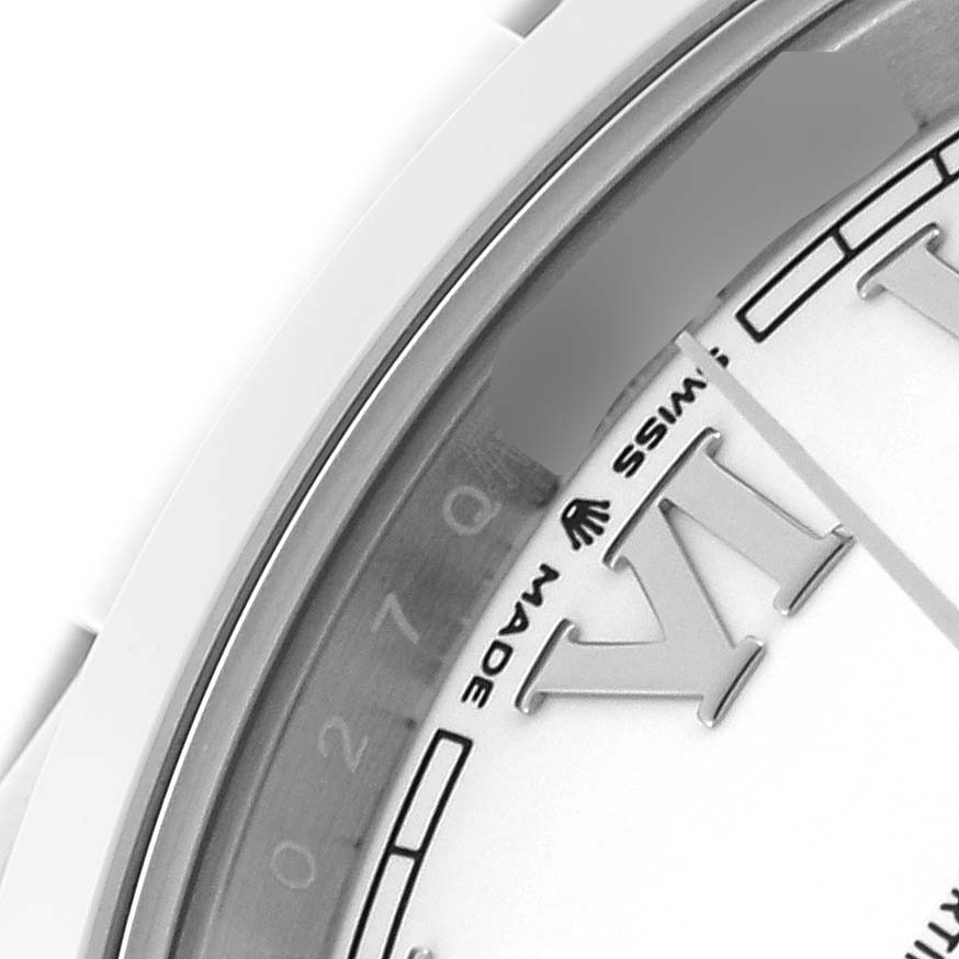 The image shows a partial view of the dial and bezel of a Rolex Datejust 41 126300 Men's Stainless Steel White Dial 126300 Men's Stainless Steel White Dial watch, focusing on the Roman numeral and text.