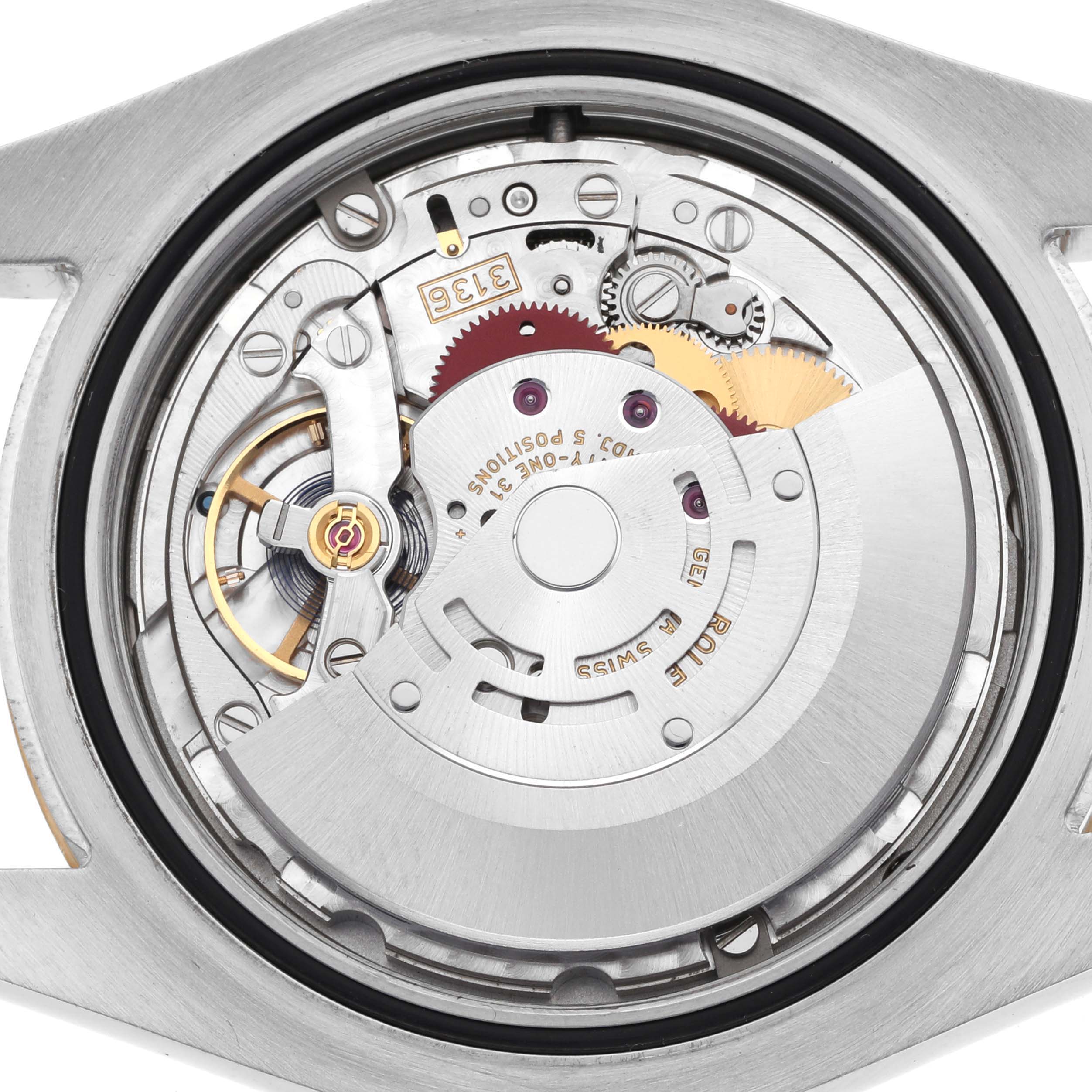 The image shows the movement of a Rolex Datejust 41 116333 Men's Steel and Gold (two tone) Champagne Dial, viewed from the back, revealing gears and intricate components.