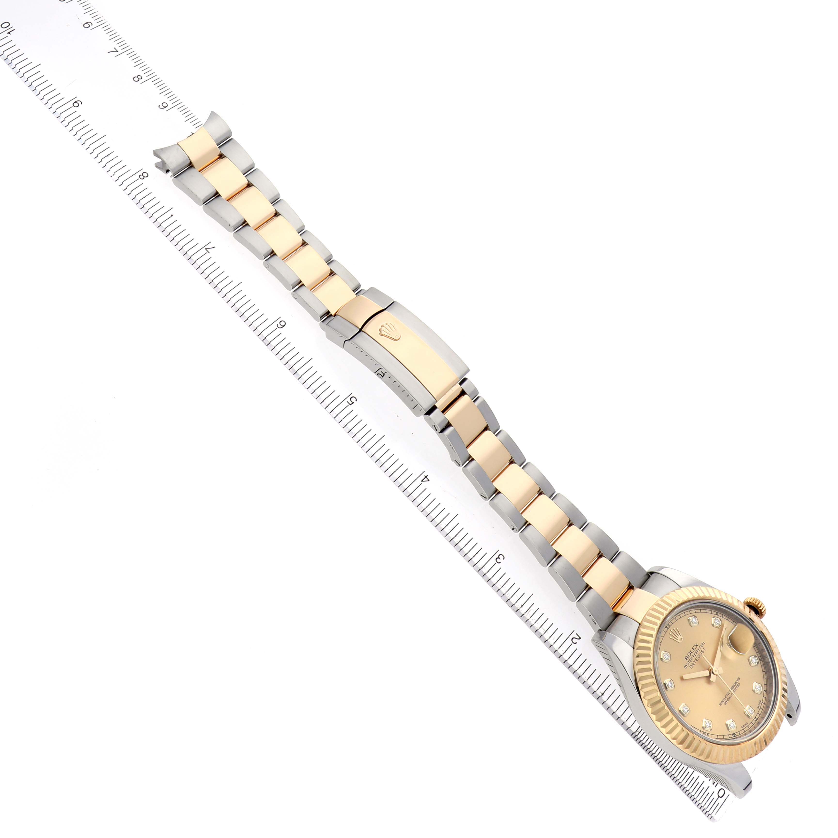The Rolex Datejust 41 116333 Men's Steel and Gold (two tone) Champagne Dial watch is shown from a top angle, displaying the bracelet, clasp, and face alongside a ruler.