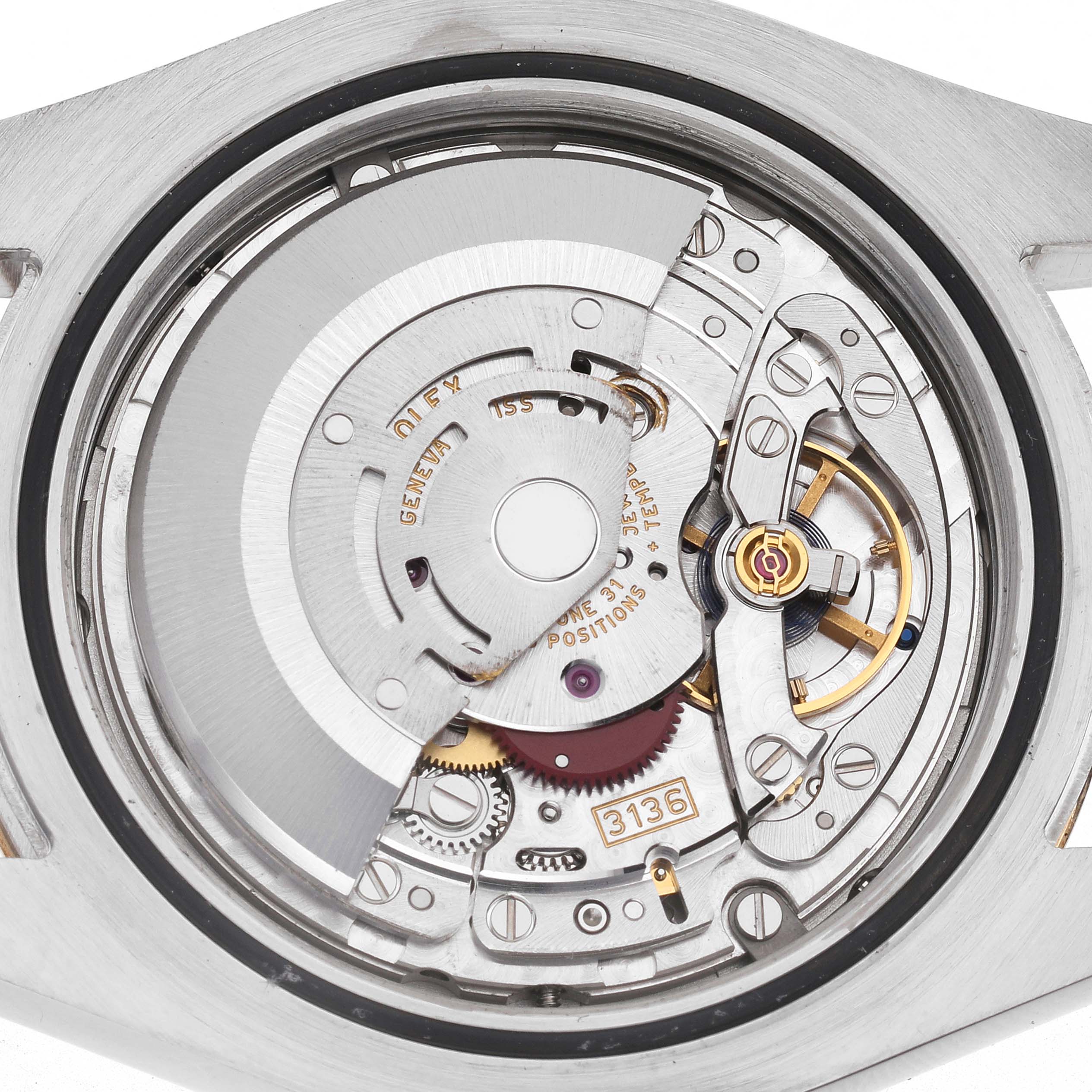 The image shows the intricate internal mechanism of the Rolex Datejust 41 116333 Men's Steel and Gold (two tone) Silver Dial, viewed from the back, highlighting its movement components.