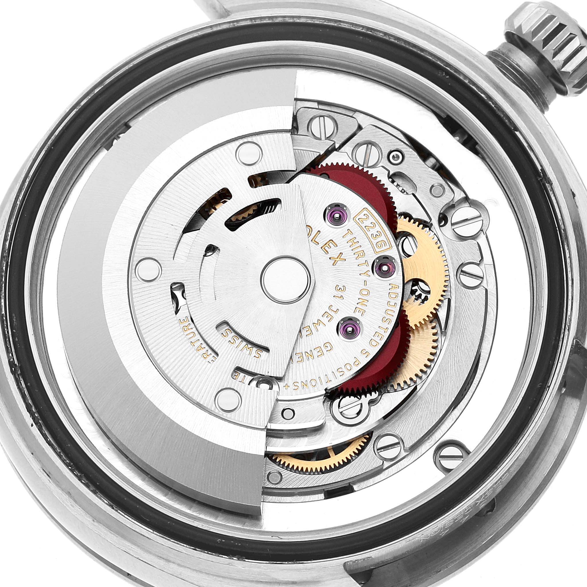 The image shows a close-up view of the internal mechanics of a Rolex Mid-Size 278344 Women's Stainless Steel Purple Dial watch, highlighting gears and movement components.