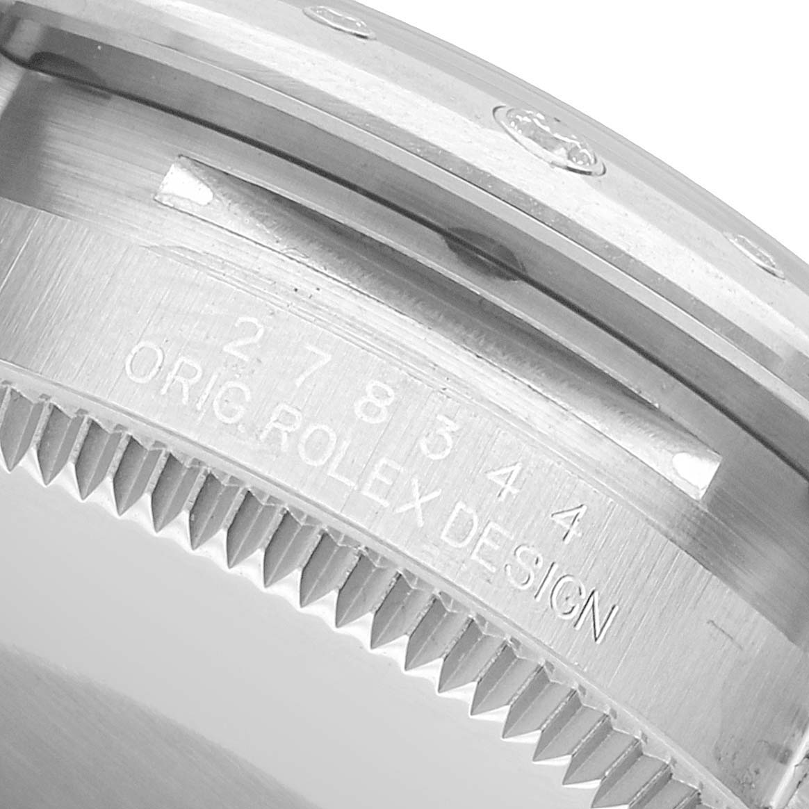The image shows a close-up of the side of a Rolex Mid-Size 278344 Women's Stainless Steel Purple Dial watch case, highlighting its serrated edge and "ORIG ROLEX DESIGN" engraving.