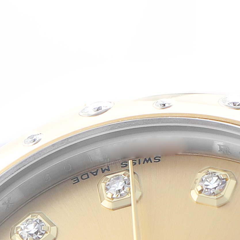 The image shows a close-up of the dial and bezel of a Rolex Mid-Size 178343 Women's Steel and Gold (two tone) Champagne Dial watch, emphasizing the diamond markers and part of the bezel.