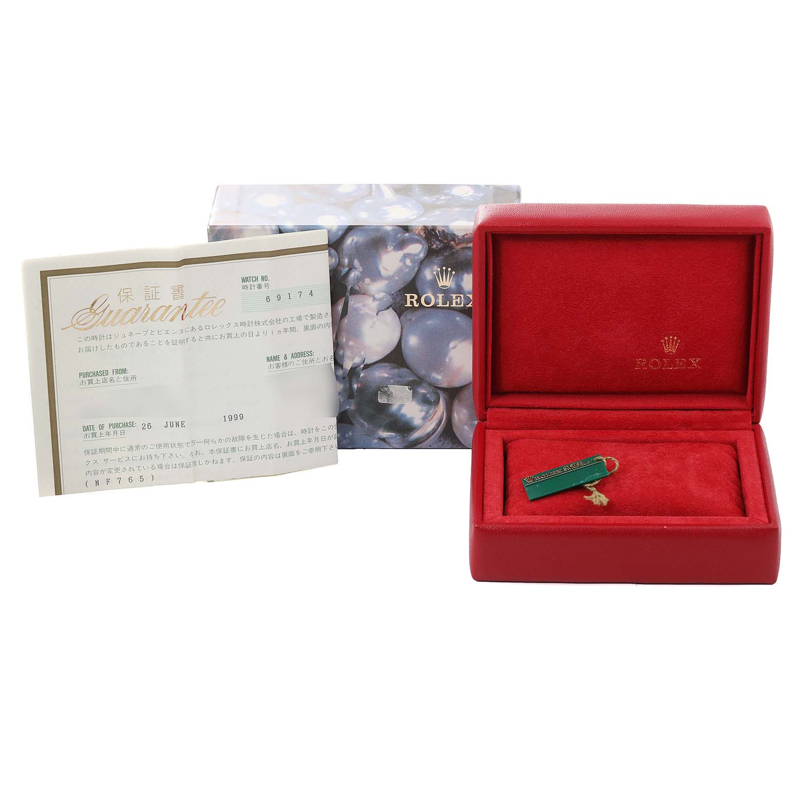 The image shows the set of accessories for a Rolex Datejust 69174 Women's Stainless Steel Silver Dial 69174 Women's Stainless Steel Silver Dial, including the watch box, guarantee certificate, and a tag.