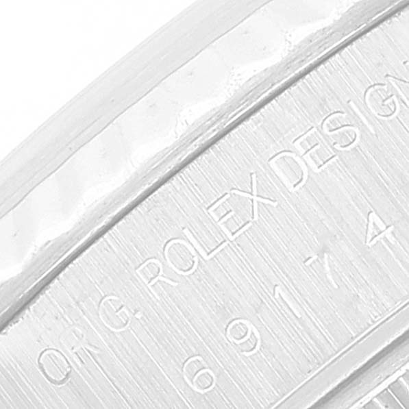 This image shows the engraved case side of the Rolex Datejust 69174 Women's Stainless Steel Silver Dial 69174 Women's Stainless Steel Silver Dial model, highlighting its design registration and serial number.