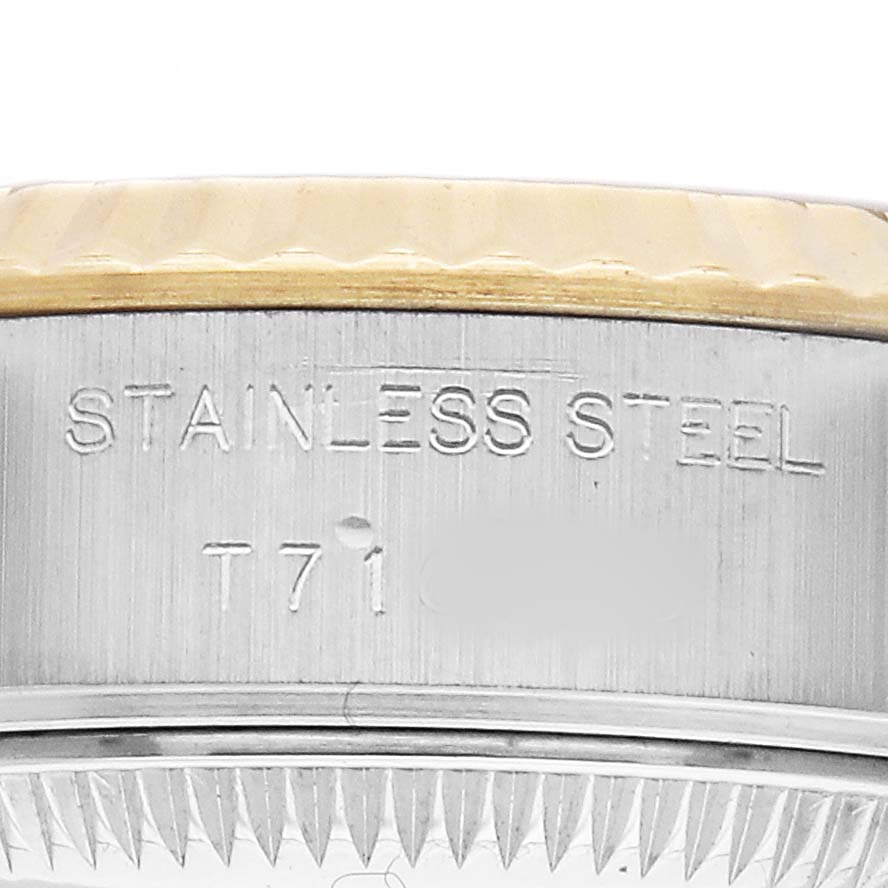 The image shows a close-up of the side of a Rolex Datejust 69173 Women's Steel and Gold (two tone) Black Dial, featuring the stainless steel engraved area and part of the bezel.