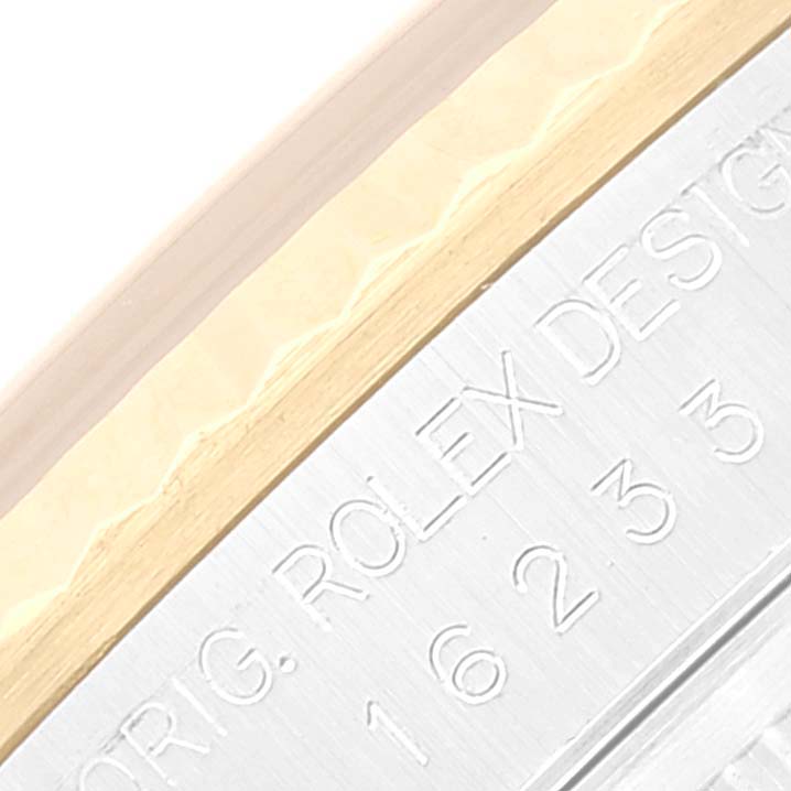 The image shows an engraved caseback edge of a Rolex Datejust 16233 Men's Steel and Gold (two tone) Black Dial 16233 Men's Steel and Gold (two tone) Black Dial watch, highlighting "ORIG. ROLEX DESIGN" and model number "16233".