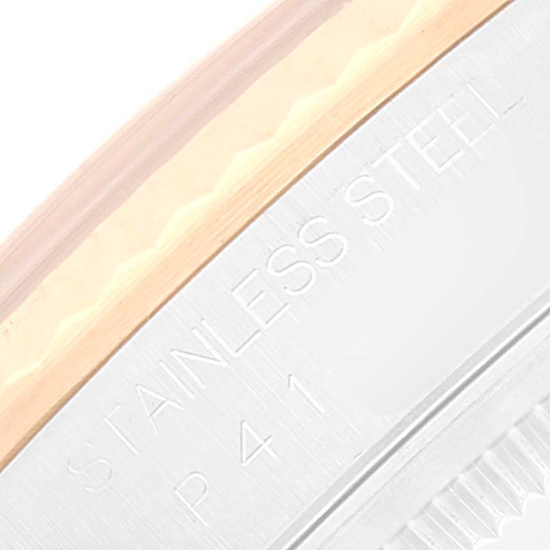 This close-up image shows a part of the bezel and edge of the dial on a Rolex Datejust 16233 Men's Steel and Gold (two tone) Black Dial 16233 Men's Steel and Gold (two tone) Black Dial watch, highlighting the "Stainless Steel" engraving.