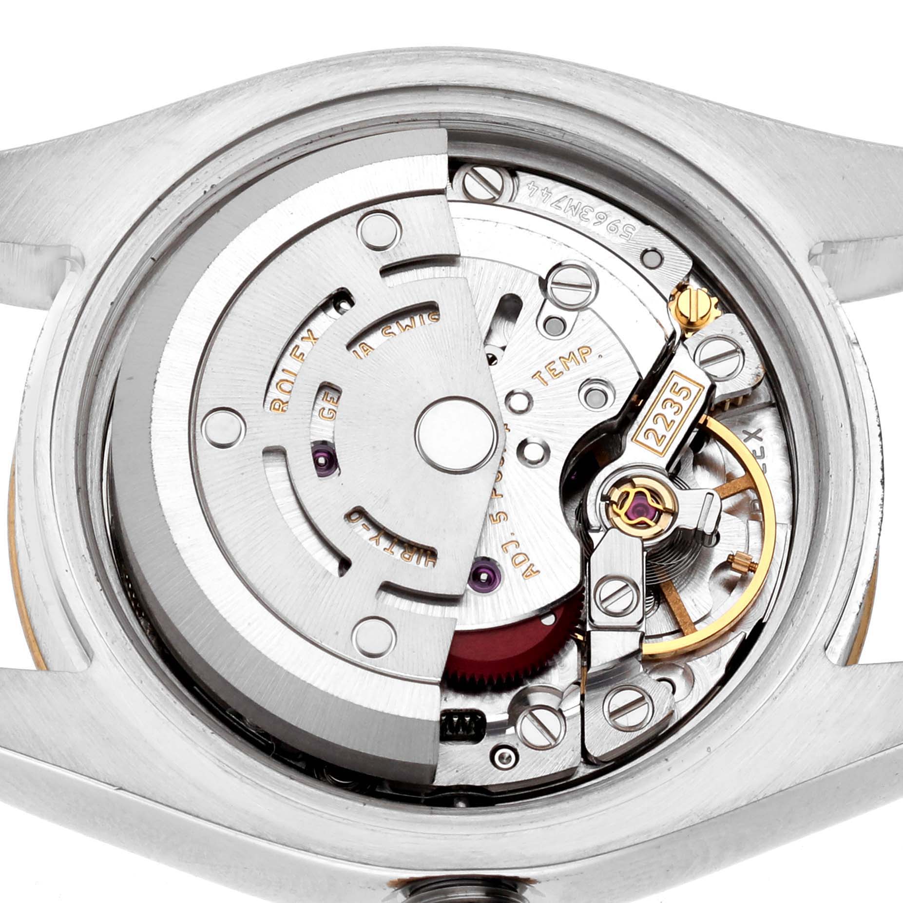 The image shows the movement of a Rolex Datejust 179173 Women's Steel and Gold (two tone) Black Dial watch viewed from the back, highlighting the rotor and gear mechanisms.