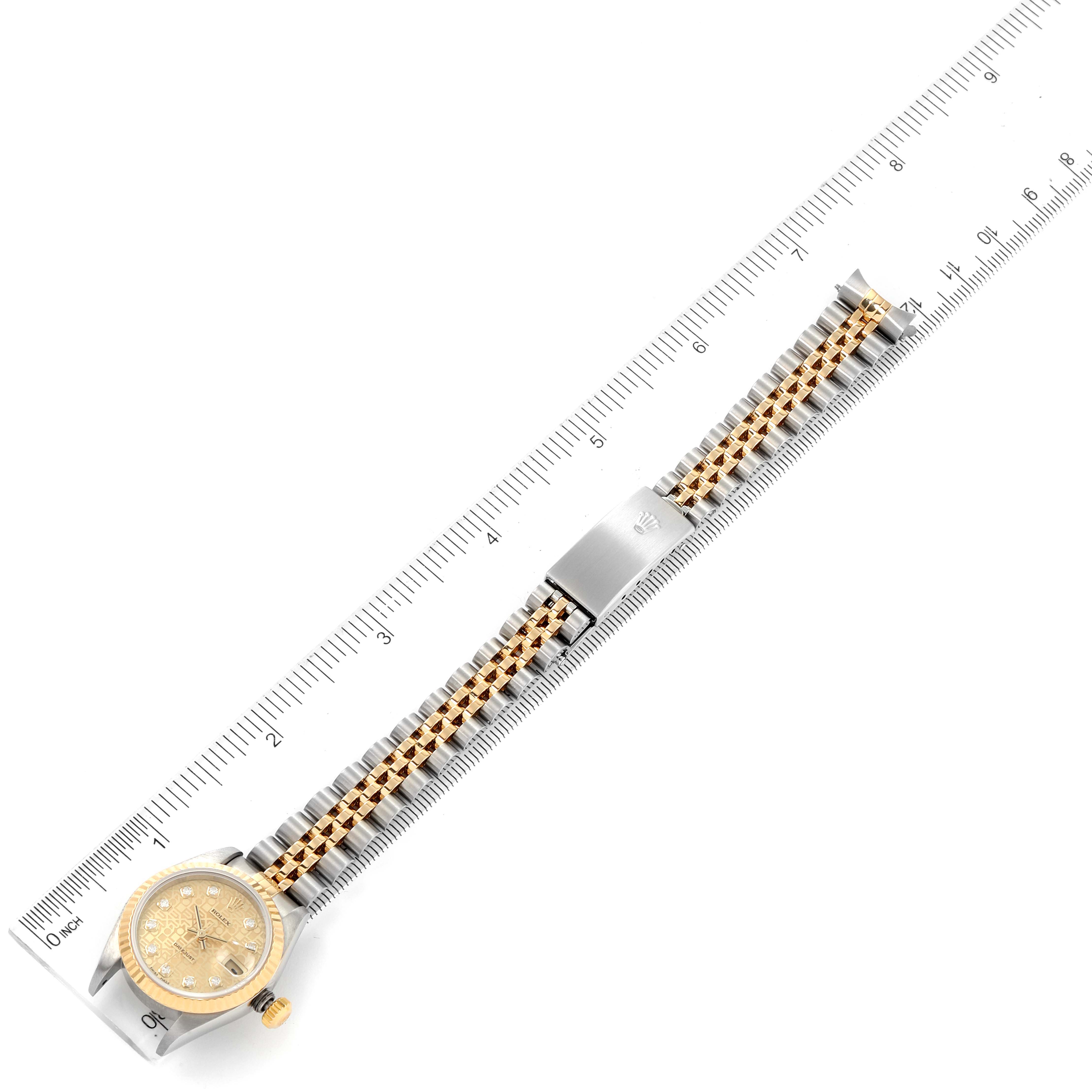 The image shows a Rolex Datejust 79173 Women's Steel and Gold (two tone) Champagne Dial 79173 Women's Steel and Gold (two tone) Champagne Dial watch laid flat next to a ruler, highlighting the watch face, clasp, and bracelet.