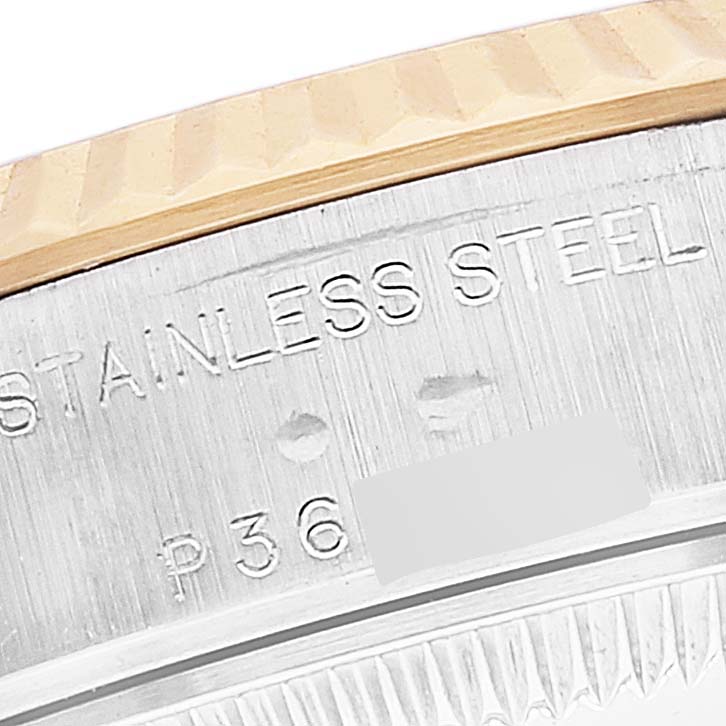 The image shows a close-up of the side of a Rolex Datejust 79173 Women's Steel and Gold (two tone) Champagne Dial 79173 Women's Steel and Gold (two tone) Champagne Dial watch, focusing on the stainless steel and part of the fluted bezel.