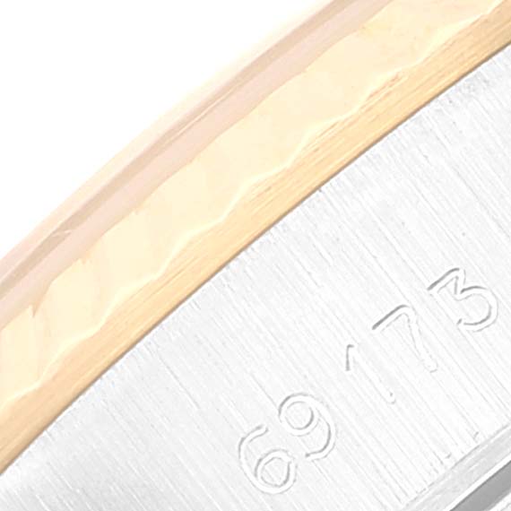 This close-up shows part of the bezel and case back of a Rolex Datejust 69173 Women's Steel and Gold (two tone) Champagne Dial 69173 Women's Steel and Gold (two tone) Champagne Dial watch, highlighting model numbers.