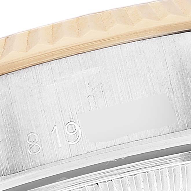 The image shows a close-up of the edge and serial number engraving on a Rolex Datejust 69173 Women's Steel and Gold (two tone) Champagne Dial 69173 Women's Steel and Gold (two tone) Champagne Dial watch.