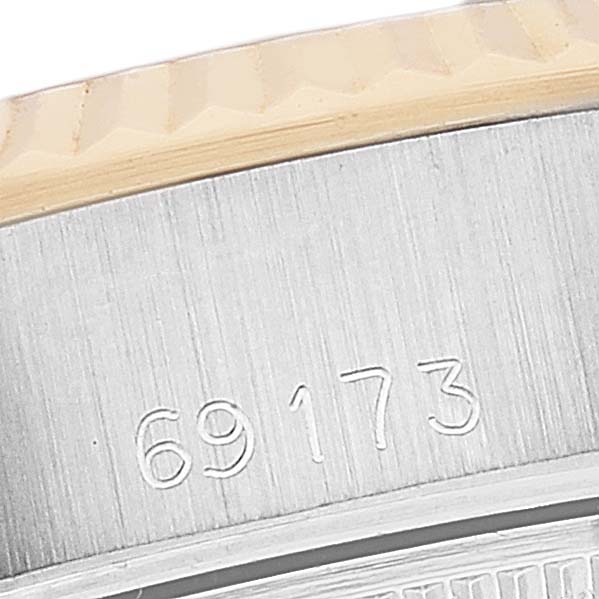 The image shows a close-up of the serial number on the side of the bezel of a Rolex Datejust 69173 Women's Steel and Gold (two tone) Champagne Dial 69173 Women's Steel and Gold (two tone) Champagne Dial watch.