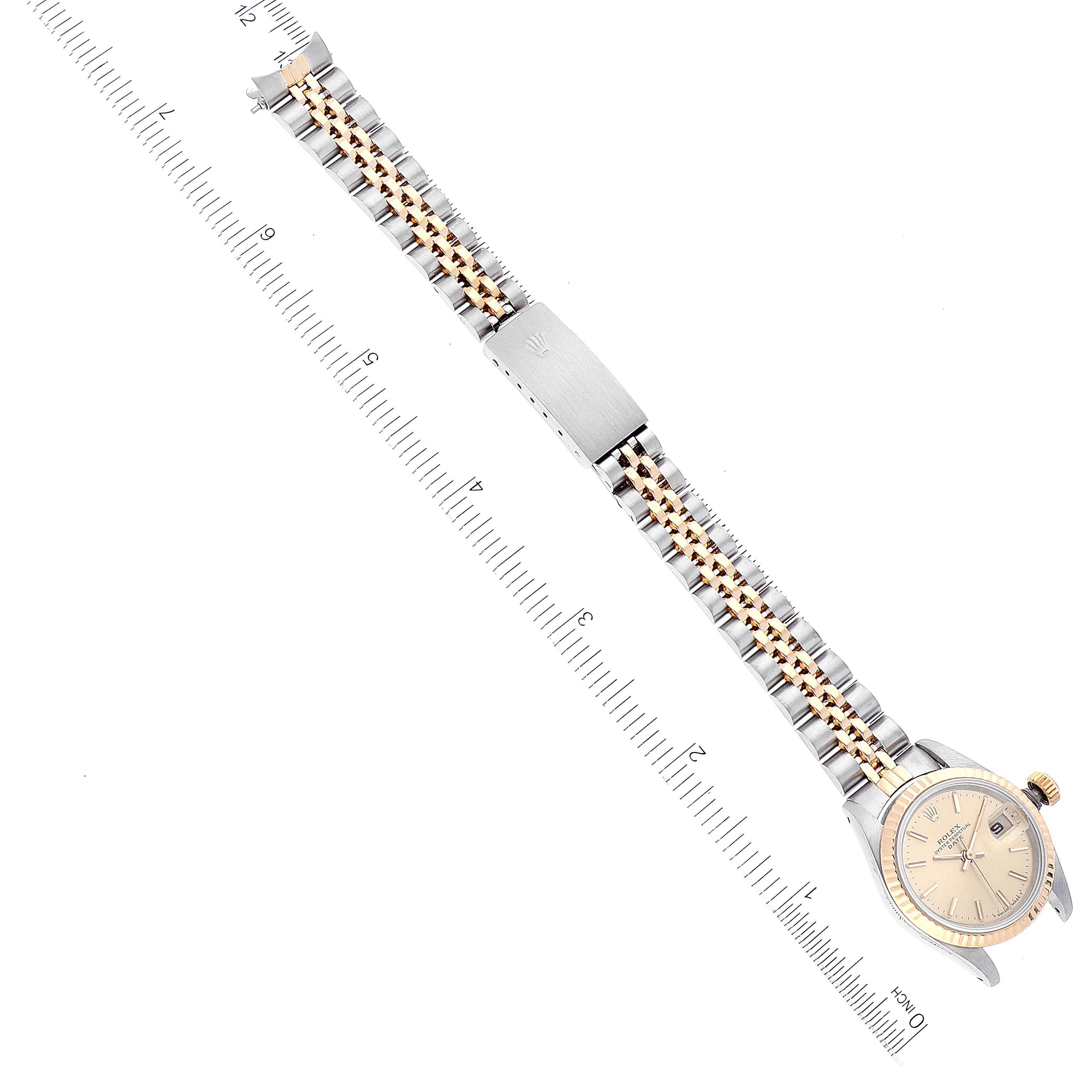 The image shows a Rolex Datejust 69173 Women's Steel and Gold (two tone) Champagne Dial 69173 Women's Steel and Gold (two tone) Champagne Dial watch at an almost horizontal angle, displaying the dial, bezel, and jubilee bracelet alongside a measuring ruler.