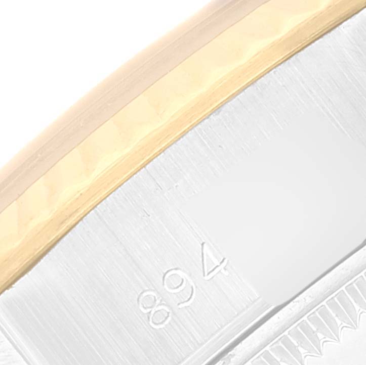 The image shows a close-up of the side of a Rolex Datejust 69173 Women's Steel and Gold (two tone) Champagne Dial 69173 Women's Steel and Gold (two tone) Champagne Dial watch, focusing on the edge of the bezel and partial serial numbers.