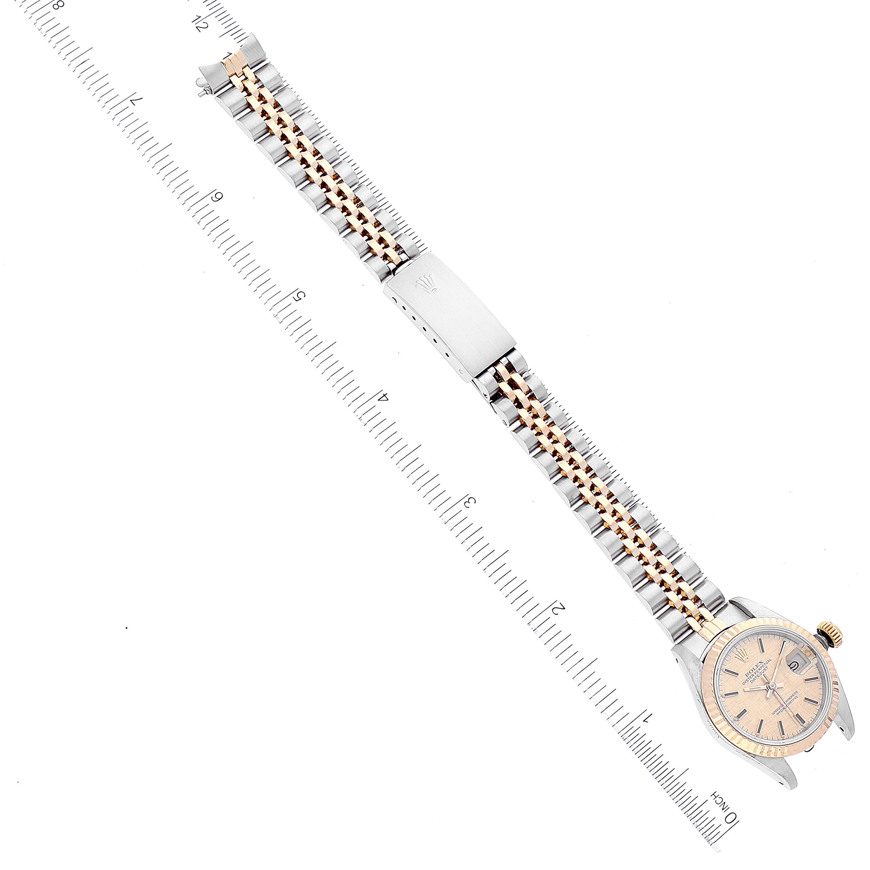 The image shows a flat-laid Rolex Datejust 69173 Women's Steel and Gold (two tone) Champagne Dial 69173 Women's Steel and Gold (two tone) Champagne Dial watch with its face and two-tone metal bracelet visible alongside a ruler for scale.