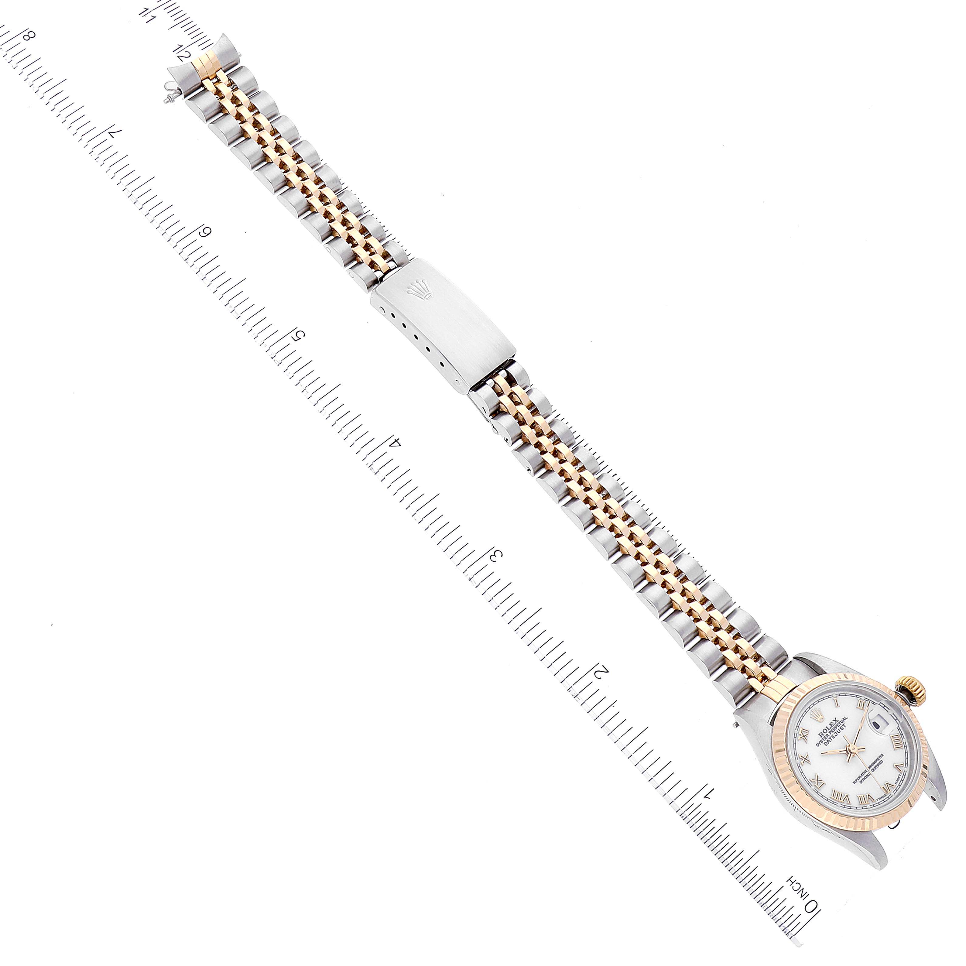 The Rolex Datejust 69173 Women's Steel and Gold (two tone) White Dial 69173 Women's Steel and Gold (two tone) White Dial watch is shown at an angle that displays the full length of the band and face, with a ruler for scale.