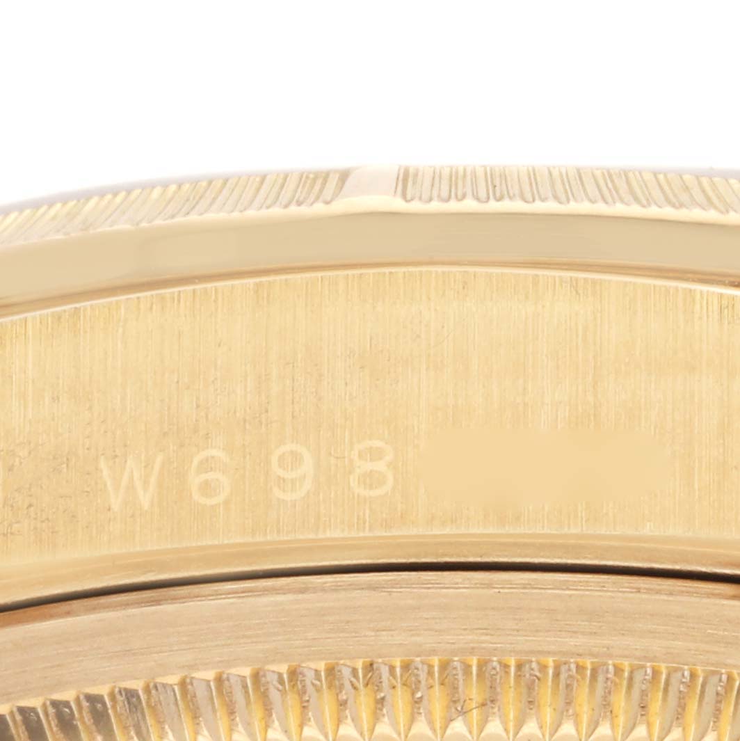 The image shows a close-up of the gold bezel and engraved edge of a Rolex President 18248 Men's Yellow Gold White Dial 18248 Men's Yellow Gold White Dial watch.