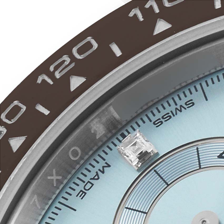 The image shows a close-up of the Rolex Daytona 116506 Men's Platinum Blue Dial 116506 Men's Platinum Blue Dial watch bezel and part of the dial, displaying a diamond hour marker and tachymetric scale.