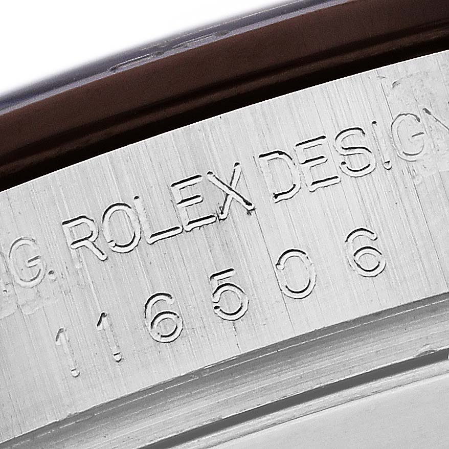 The image shows a close-up of the engraved case side of the Rolex Daytona 116506 Men's Platinum Blue Dial 116506 Men's Platinum Blue Dial model, displaying "ROLEX DESIGN" and model number.