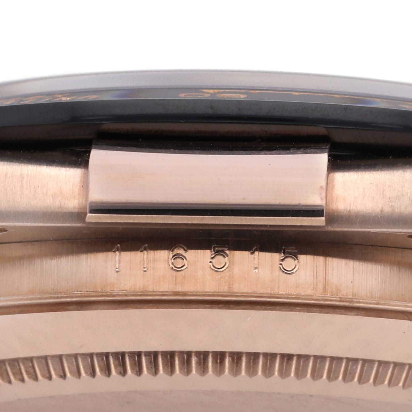 The image shows the side view of the Rolex Daytona 116515LN Men's Rose Gold Black Dial 116515LN Men's Rose Gold Black Dial's case, focusing on the serial number and part of the bezel.