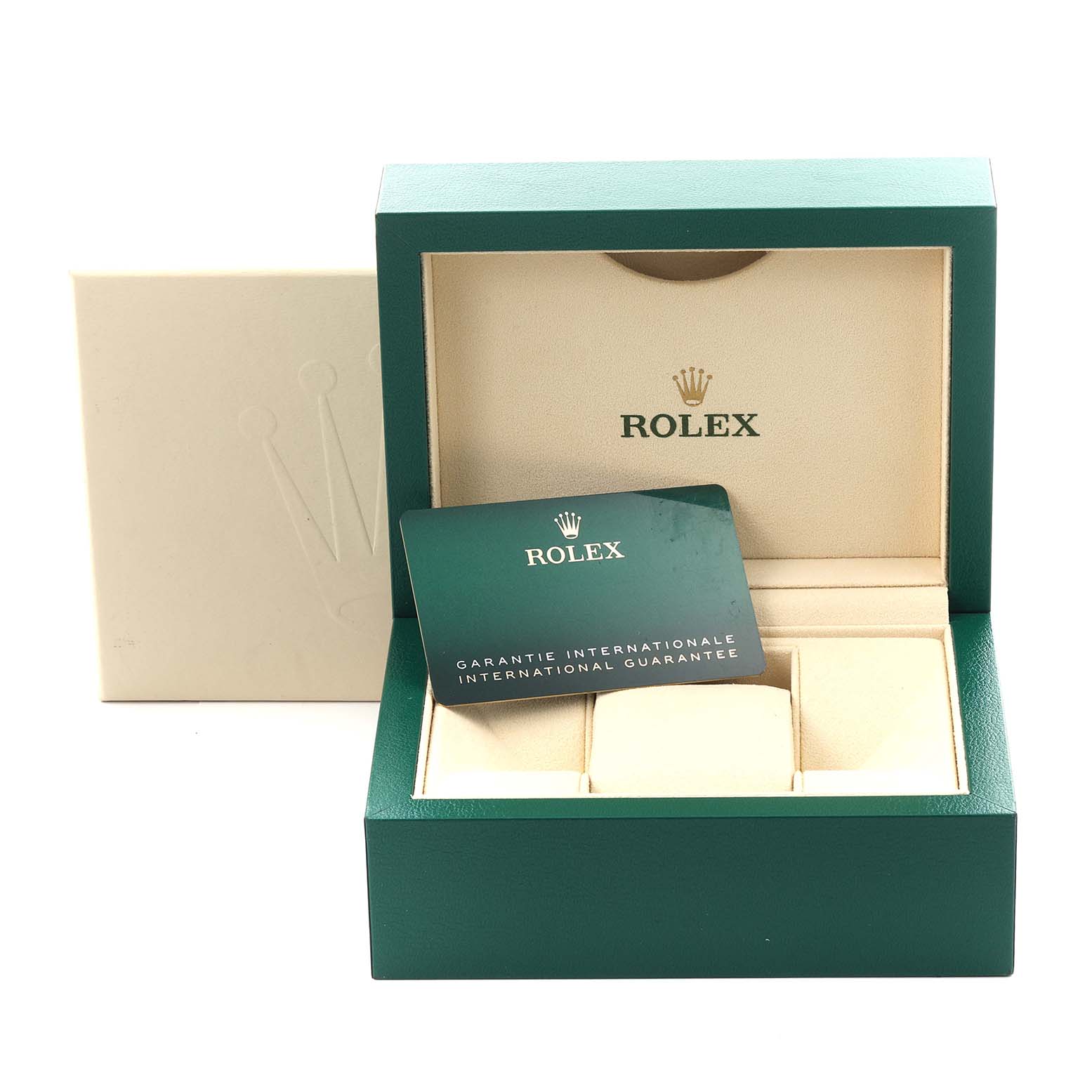The image shows a Daytona model Rolex box, open at an angle, with an international guarantee card inside.
