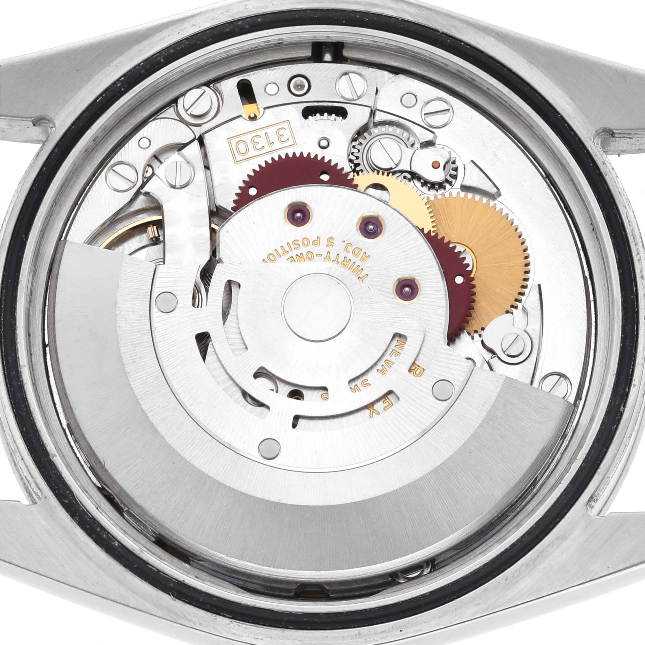 The image shows the inside movement of a Rolex Explorer 114270 Men's Stainless Steel Black Dial 114270 Men's Stainless Steel Black Dial watch from a top-down angle, highlighting gears and the rotor.