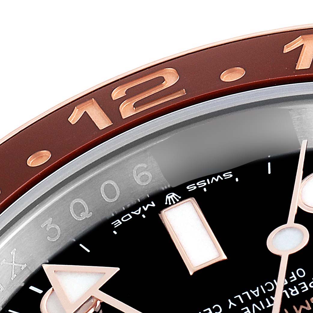 This close-up image of the Rolex GMT-Master 126711 Men's Stainless Steel Black Dial 126711 Men's Stainless Steel Black Dial watch shows a portion of the bezel, dial, and hands.